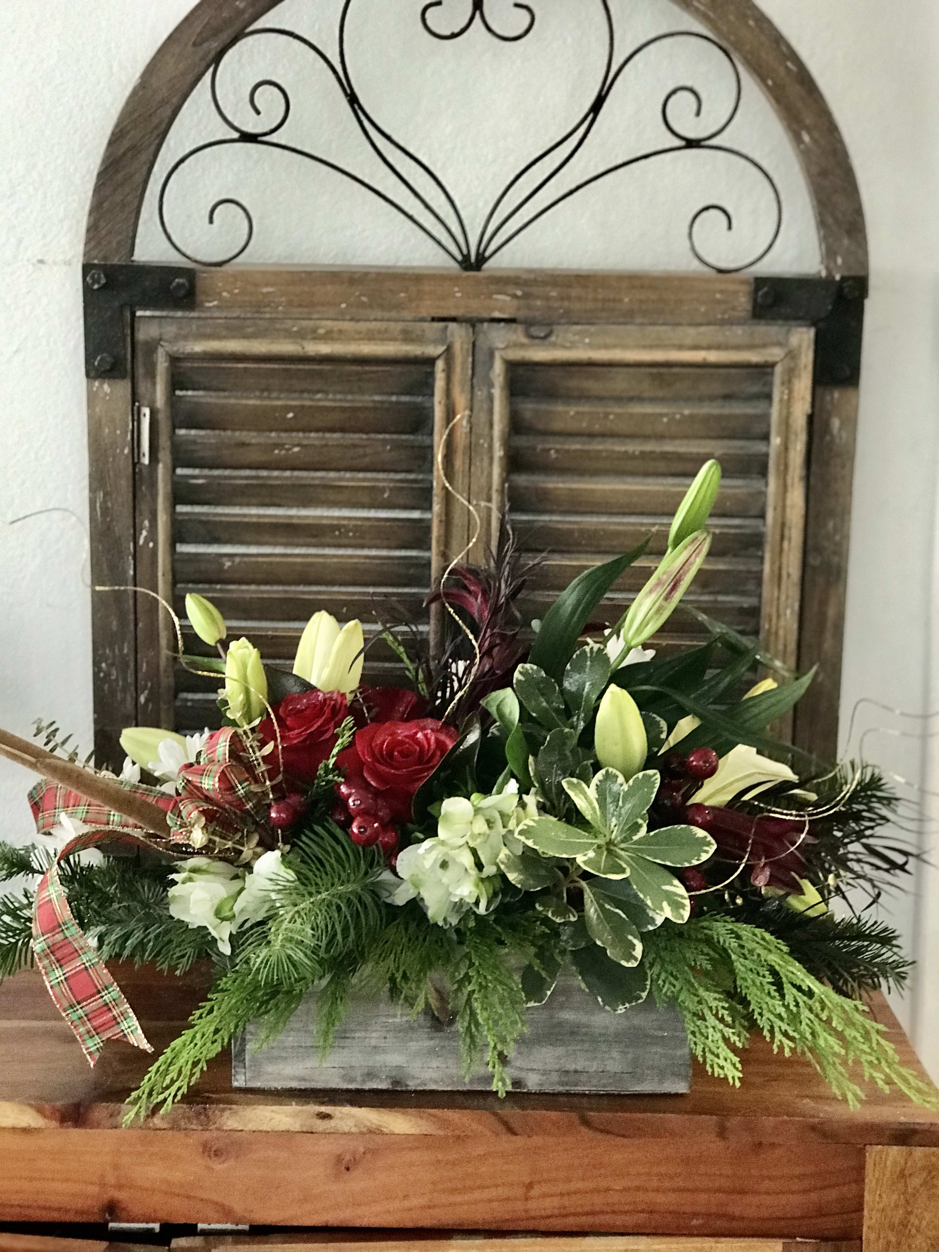 A Jolly Surprise - This arrangement will surprise that special one.It contains roses, lilies, berries, alstroemeria, and greenery.