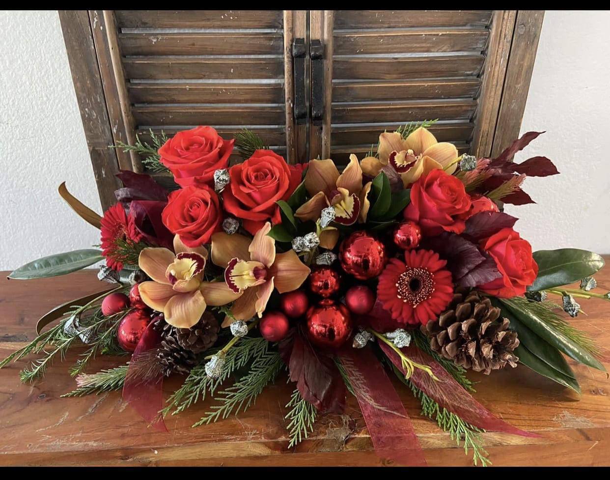 Christmas Center piece  - Fett and half center piece with orchids and pinecones.