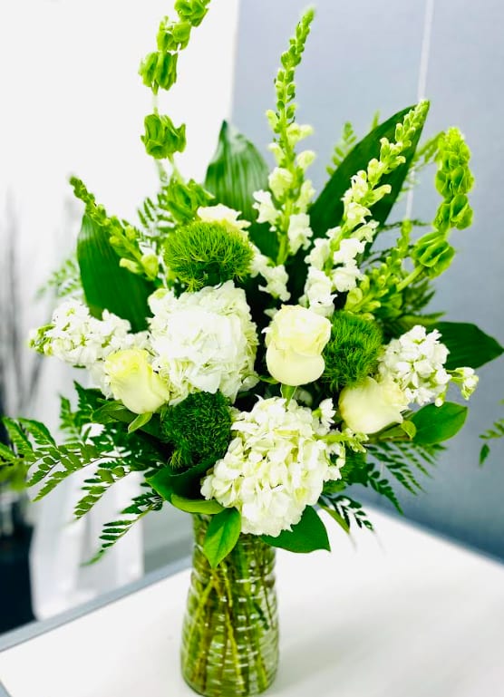 Botanic Beauty - A modern accent for any occasion, this beautiful botanical sculpture blends snow white hydrangea and roses with unique greens for a peaceful, Eastern-inspired feel. (standard pictured one sided) Deluxe one sided. Premium 360. 