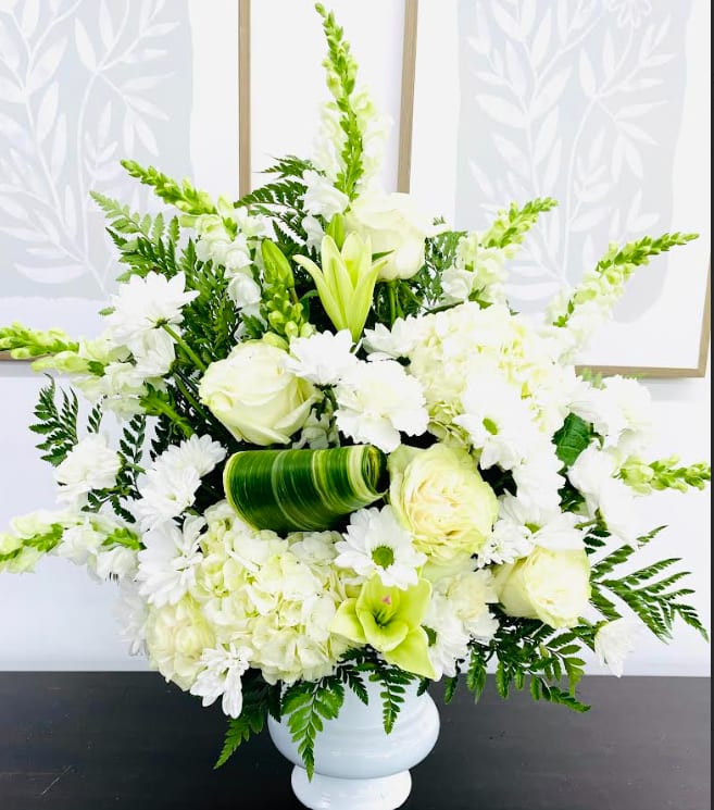 Clouds of Peace - As serene as gently falling snow, this elegant white arrangement in a large antiqued pot is a heartfelt symbol of peace and beauty, a memory that will remain a guiding light to your loved ones for years to come. (picture shown at premium) 