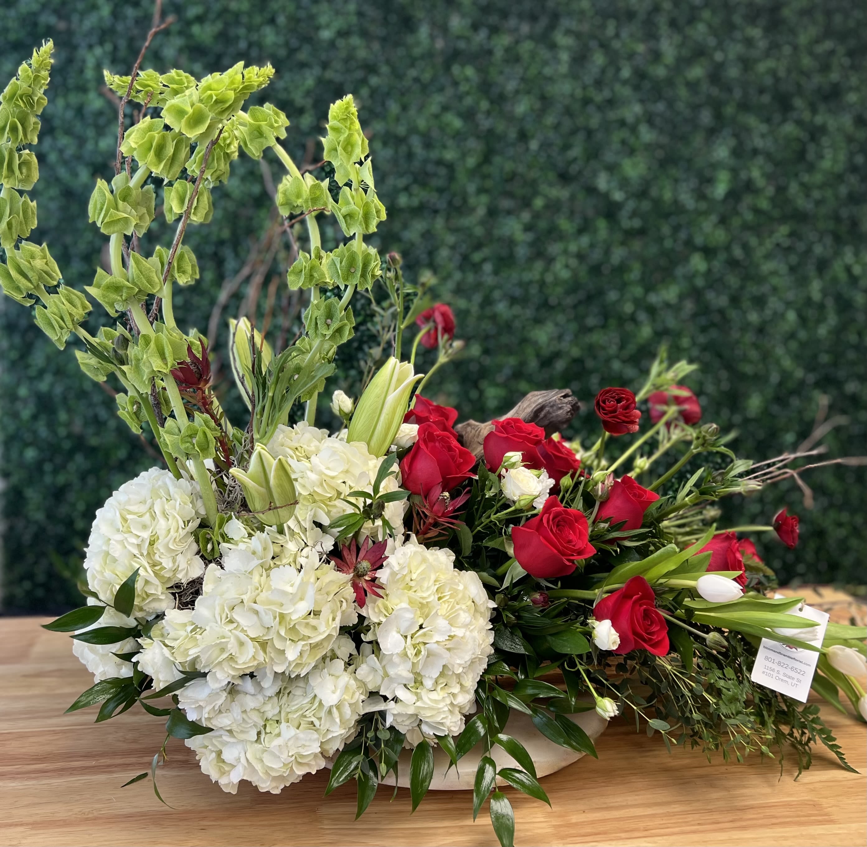 Celebrating Life - Gorgeous hydrangea, Red Roses, Safari Sunset, Tulips, Ranunculus, Birch branches, Belles of Ireland, Eucalyptus, Italian Ruscus and in season foliage this arrangement was designed to bring memories of a life well lived! 28&quot; H x 32&quot; Long. Red and White not your colors? Leave your preference in the notes and we will accommodate if possible or call you!
