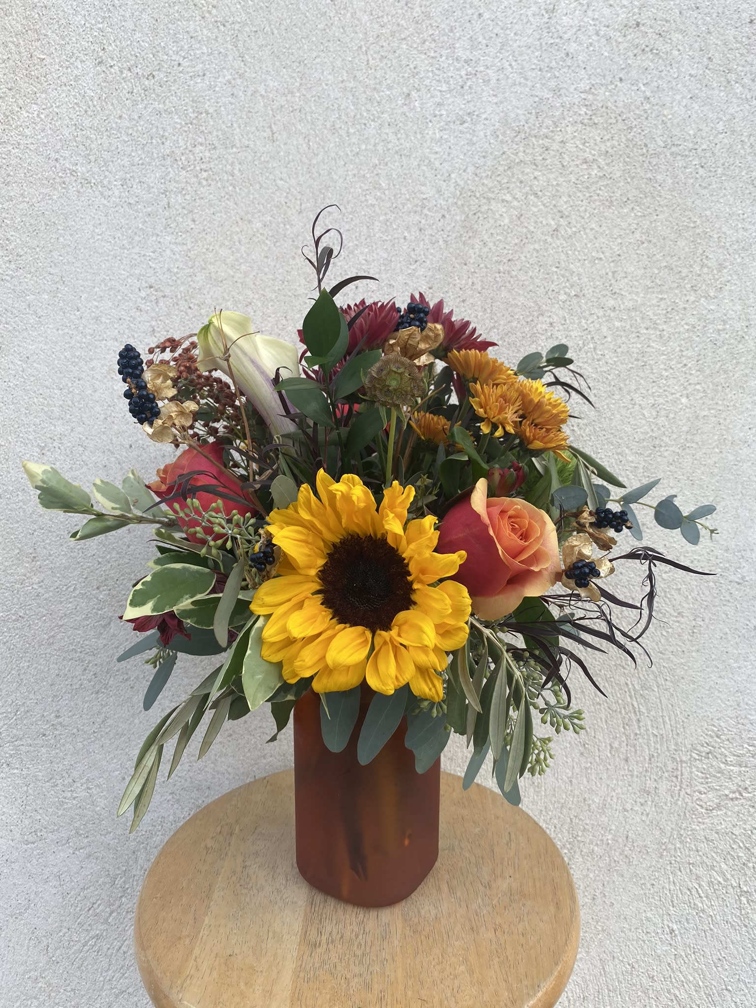 Fall Campfire Jar - Designer's Choice  - A designer's choice arrangement of flowers in a similar look and feel created out of the shown glass jar in either yellow, orange or red. Shown is $75 price point. 