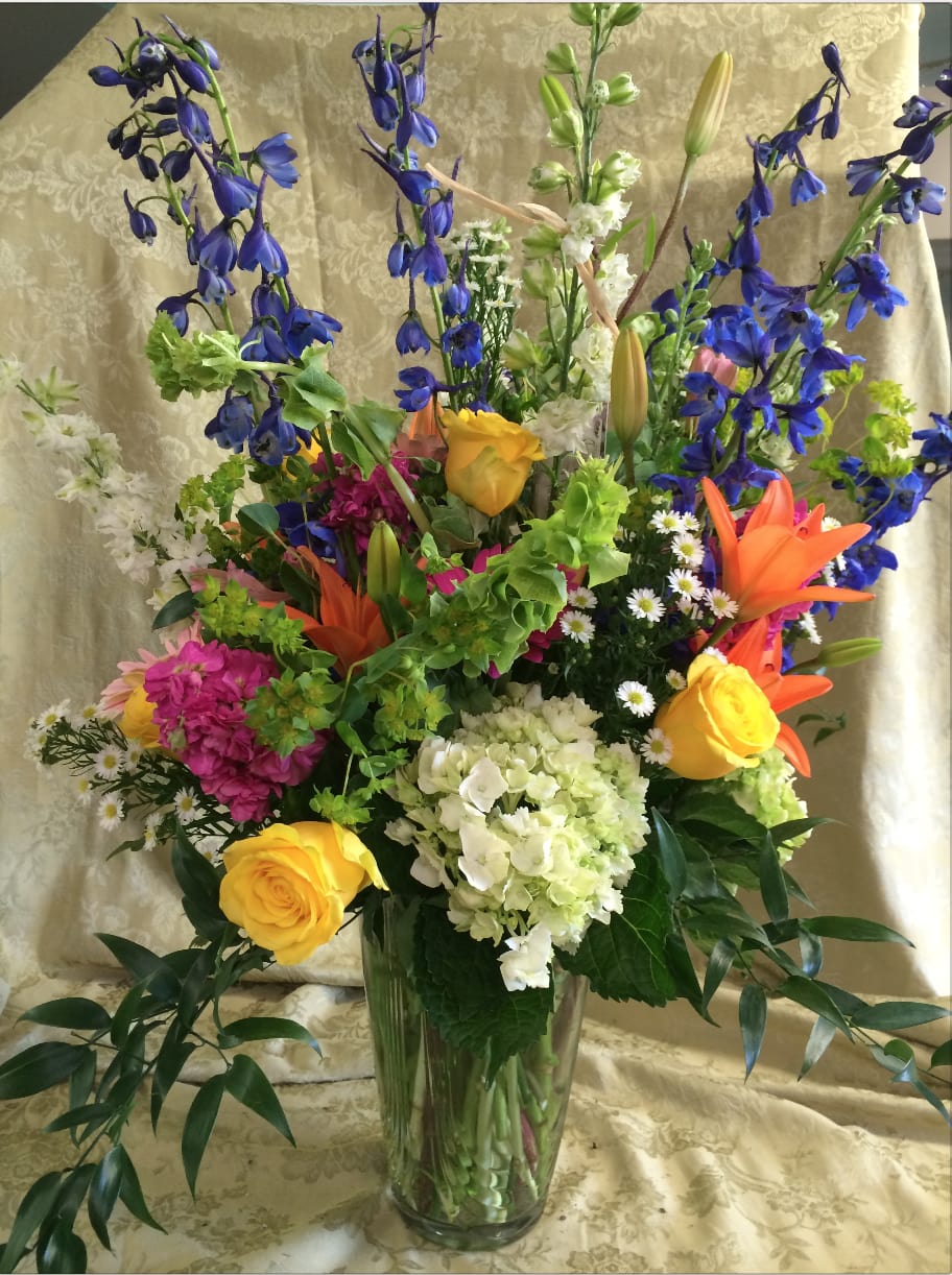 Garden Delight - A Beautiful garden arrangement perfect for any occasion.  A glorious mixture of the fresh blooms we have on hand when your order is placed creatively designed in a simple vase to accentuate each and every flower.  Each design makes a statement  - unique...custom...just for you!