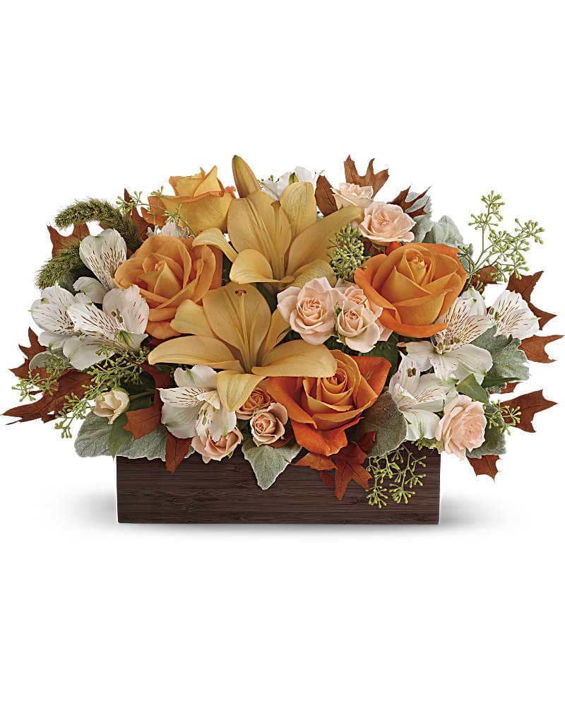 Fall Chic Bouquet - Simply chic and overflowing with fall blooms! This gorgeous arrangement is sure to impress with its glorious shades of autumn - combining orange roses, peach lilies and seasonal brown leaves. Hand-delivered in a dark-toned bamboo rectangle. This impressive arrangement features light orange and peach roses, peach asiatic lilies and white alstroemeria, and finished with dusty miller, seeded eucalyptus and millet.