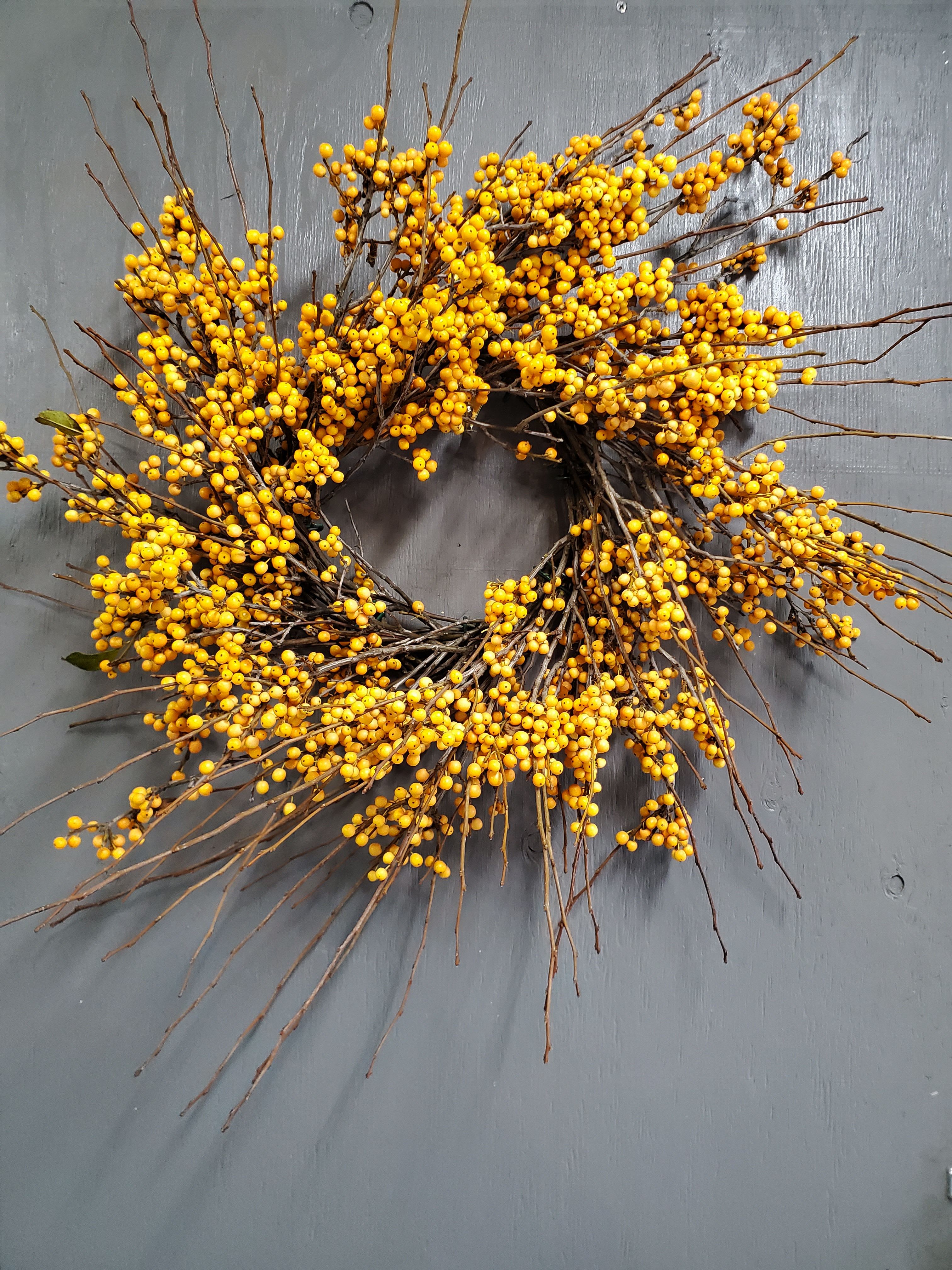 Yellow Ilex Wreath  - A fresh mix of stems chosen for their color and character—ready to be shaped into a personal masterpiece.  Important Note: We are a custom design studio florist in a small town. Every bouquet we create is a one-of-a-kind creation, tailored to the season, availability of flowers, color choice, artistic interpretation, and the current materials available. The photos do not represent the exact flowers that will be delivered. They are intended to provide you with an idea of what we do, how we do it, and the variance that can be expected. 