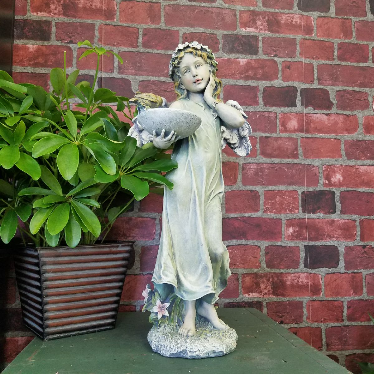 Angel Holding Birdfeeder - Wonderfully detailed resin angel of a standing angel holding a birdfeeder. If you are unsure about a plant or flowers, consider this as an option that will help express your thoughts. Angel 20&quot; tall.