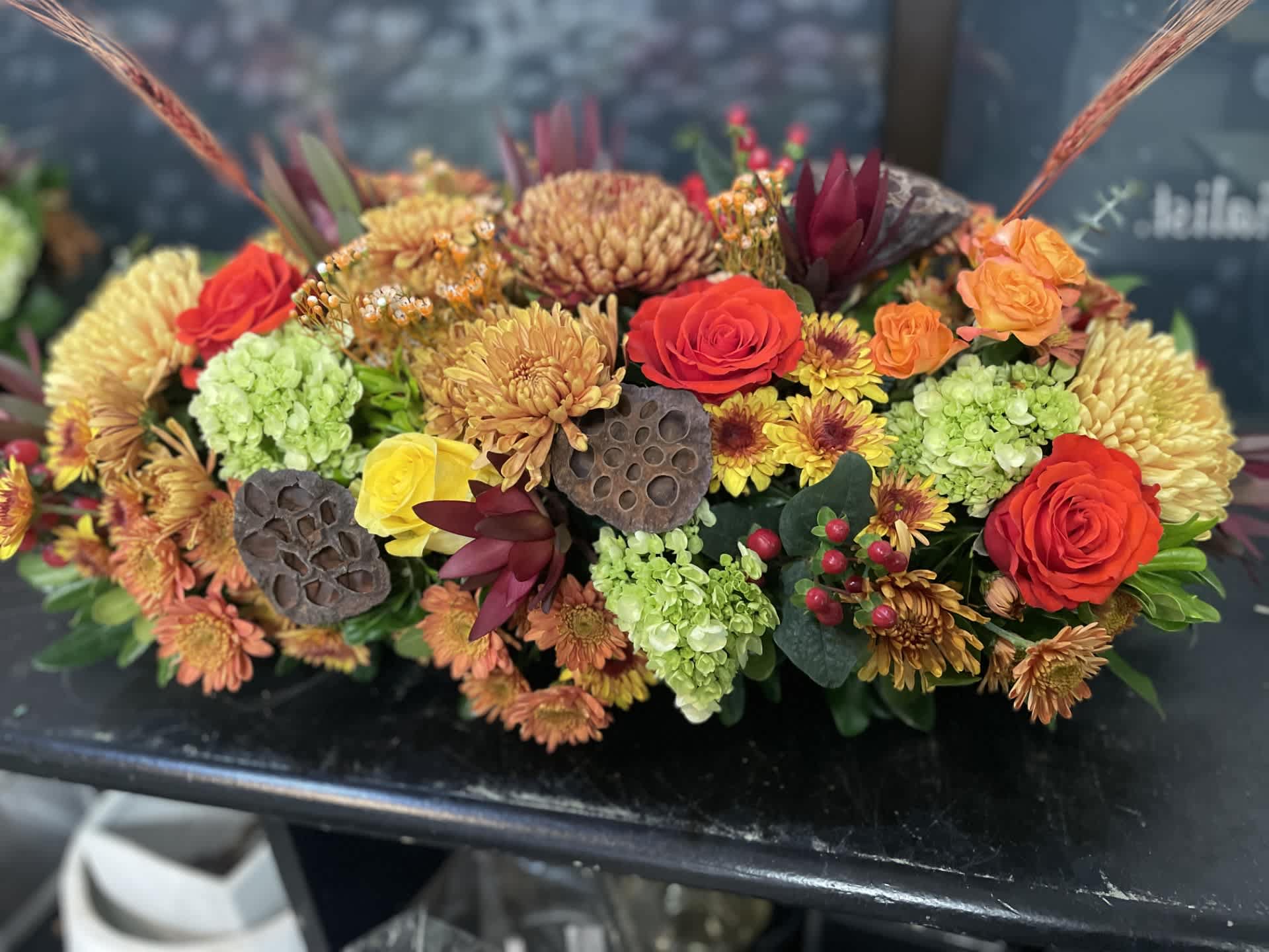 A Family Thanksgiving 2024- LARGE - ORDER EARLY - This is a beautiful centerpiece that's sure to please. Measures  overall 21-24 inches long and 10 inches tall, perfect to compliment any table seating 6-10 people. Packed with Fall Mixed and Perfect for larger tables- 