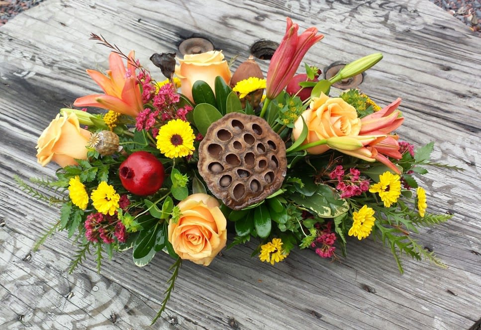 HOLIDAY TABLE ARRANGEMENT - This beautiful Holiday table arrangement is sure to please.  Filled with holiday / fall flowers, to compliment any table - Also send as that perfect gift to those special loved ones - Measures overall ( Including flowers ) aprox 16 inches long X 10 Inches tall ONLY for THANKSGIVING