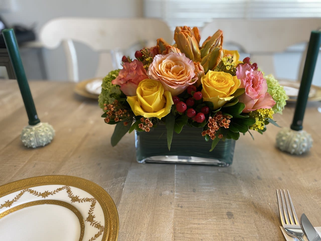 Fall table Centerpiece  - The best things do come in small packages - This beautiful table centerpiece is perfect for an intimate small gathering, but filled with some of the best flowers available - Made in an 8 inch glass rectangle vase with 4 different color Roses / mini green Hydrangea / Orange Parrott Tulips  / Hypericum Berries and accented with Orange Waxflowers and greens.