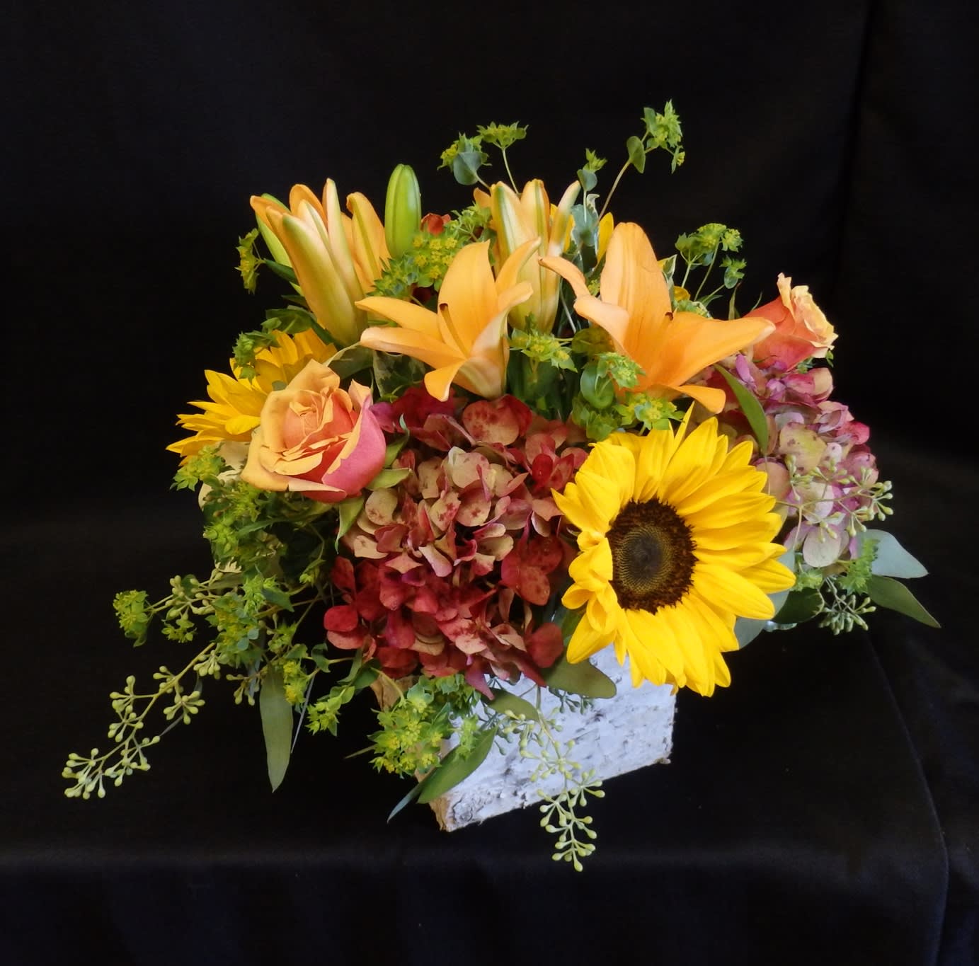Blazing Birch - “Blazing Birch” is a vibrant fall arrangement featuring golden sunflowers, orange lilies, roses, and rich hydrangeas, all beautifully designed in a rustic birch wood box. A warm and cheerful display, perfect for bringing seasonal charm to any home or celebration in Danville, CA.