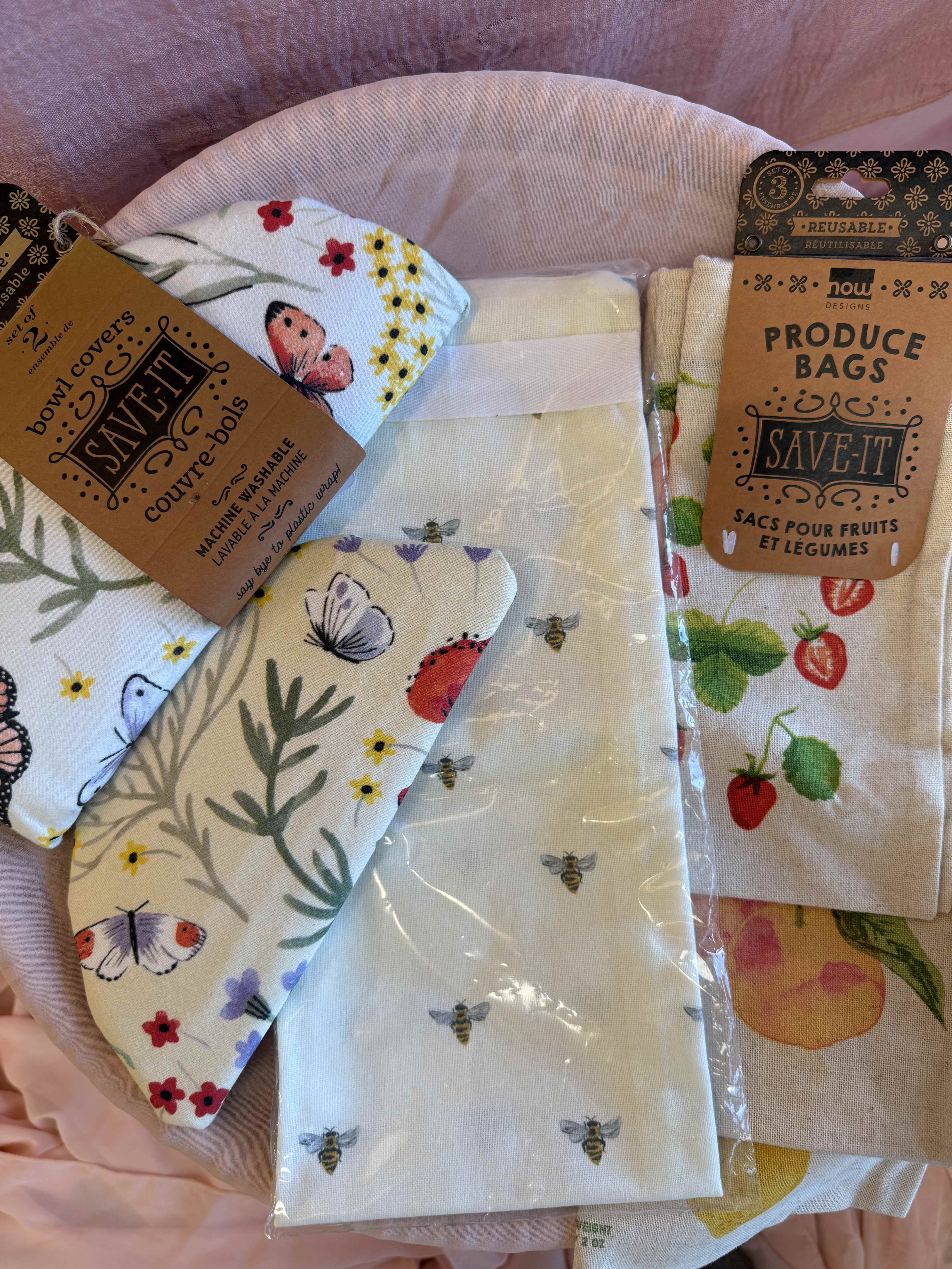 The Eco Chic Gift Basket - Bring a little sustainability and style to the heart of the home. This thoughtful set includes 2 reusable food safe lining bowl covers, 3 reusable fruit &amp; vegtable drawstring bags and a bee tea towel. Perfect for the eco-minded cooks who loves a touch of charm in their kitchen. Say goodbye to single use plastic and hello to greener living!  Gift basket includes:  1  Now designs by Danica, Save - It bowl cover set of 2 butterfly &amp; floral (fits up to 10.5&quot; / 27cm diameter &amp; 9&quot; / 24cm )  1 Now designs by Danica, Save - it produce bags set of 3 fruits ( 3 sizes: 8 x 10 / 10 x 13 / 12 x 16)  1 1canoe2 Honey Bee Kitchen Towel