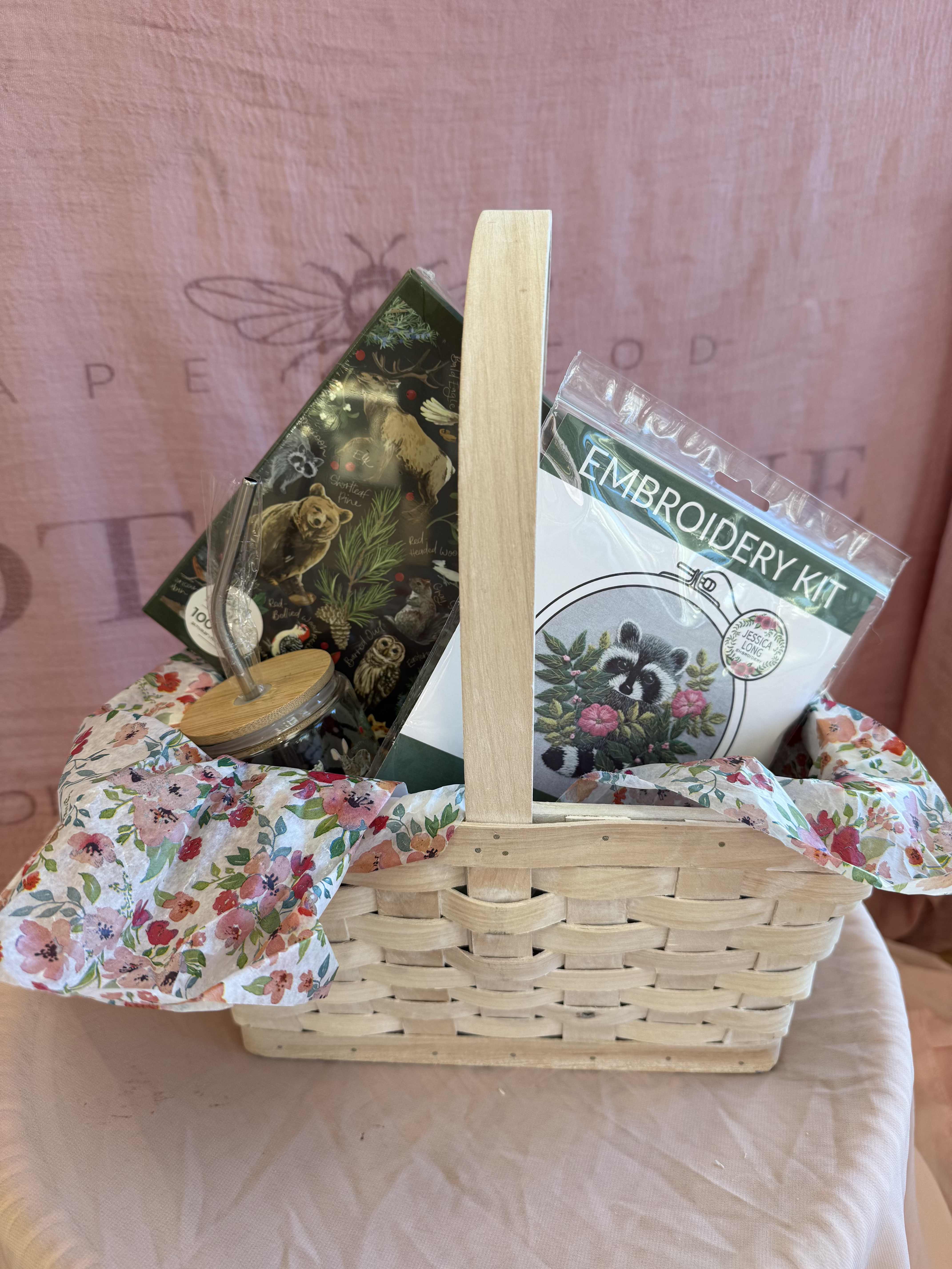 The Wild &amp; Whimsy Gift Set - For the nature lover with a creative heart. This charming set brings a touch of the wild indoors with a flora &amp; fauna puzzle a matching glass cup with a metal draw and a raccoon embroidery kit to stitch up some woodland magic. Perfect for cozy afternoons spent crafting, puzzling &amp; daydreaming about the great outdoors.   Gift Basket Includes:  1 1Canoe2 Winter Flora &amp; Fauna Puzzle, 1000 pieces 1 1Canoe2 Winter Flora &amp; Fauna Glass with a metal straw 1 Jessica Long Embroidery kit - Raccoon,