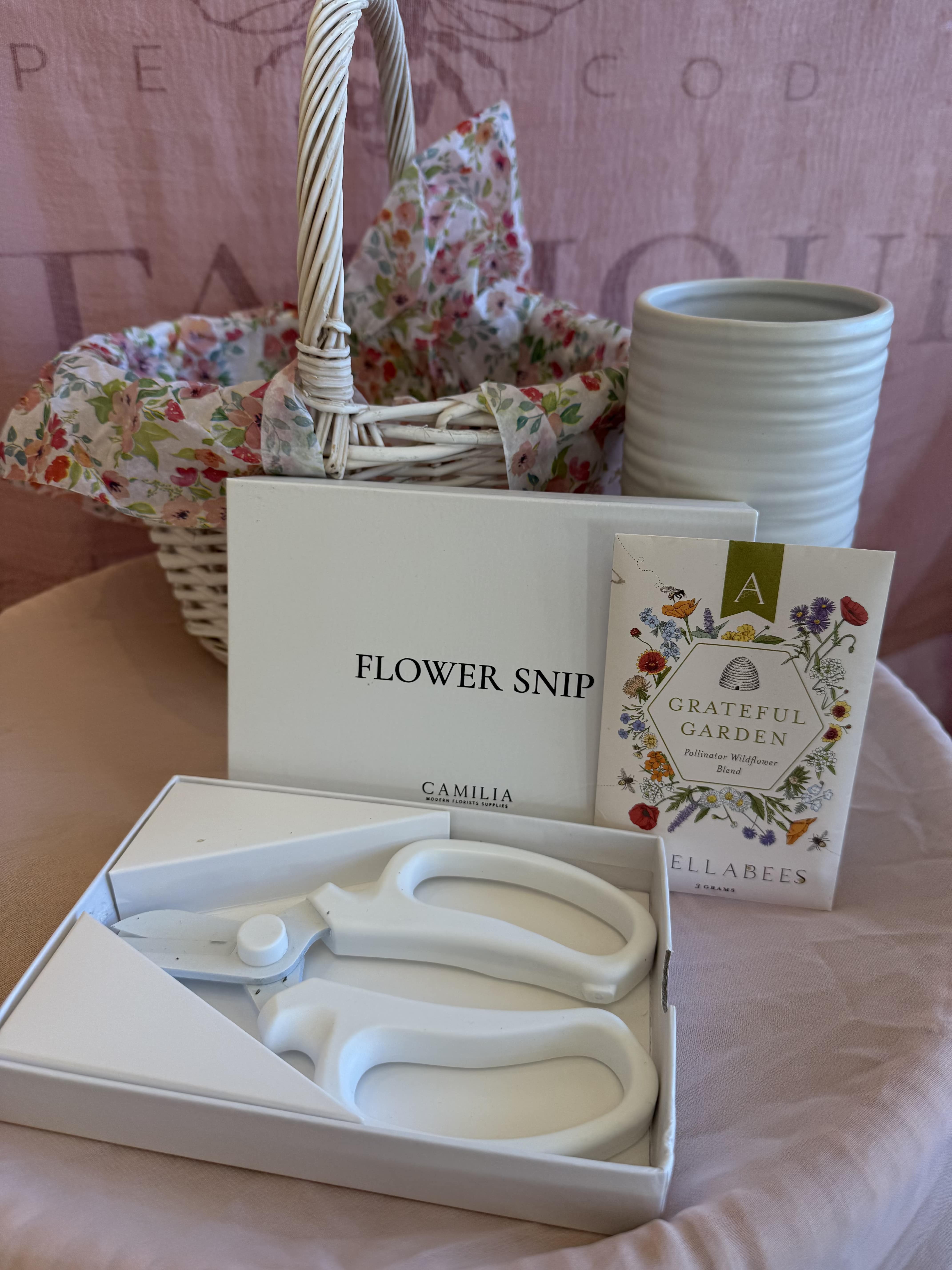 Snip, Sow, Grow Gift Basket - For the gardener at heart! This delightful set includes a white flower vase for freshly cut blooms, a handy pair of floral snips for tending and trimming and a packet of wildflower seeds to start something beautiful. The perfect gift for anyone who loves to play in the garden.   Gift Basket includes:  1 Everest White Vase - 3.5x7&quot; 1 Camilia Flower Snips, White  1 Anellabees wildflower blend packet 