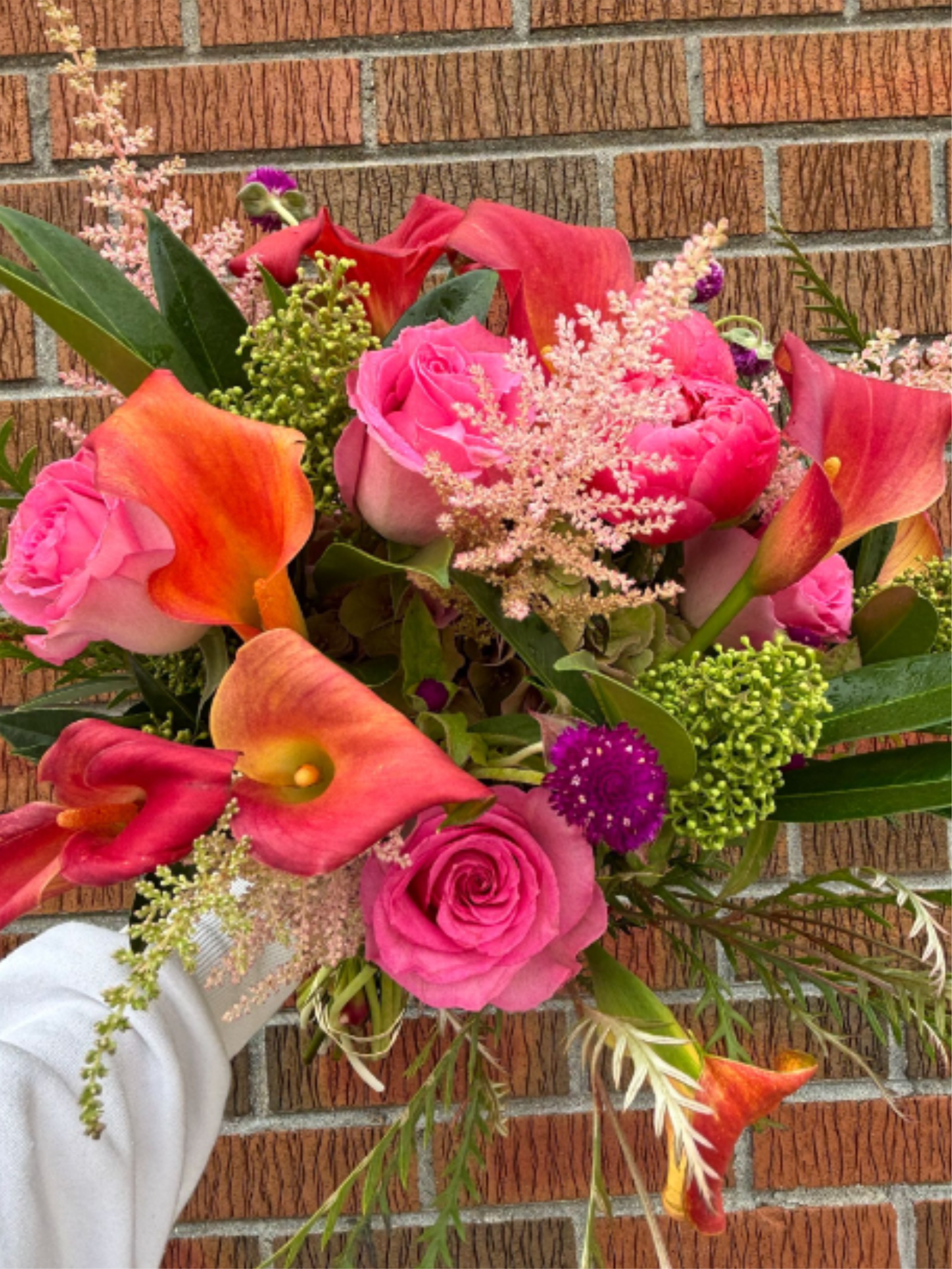 Winter 5 - A vibrant winter mix featuring peonies, calla lilies, pink roses and lush seasonal greens.  *Depends on availability, flowers may change