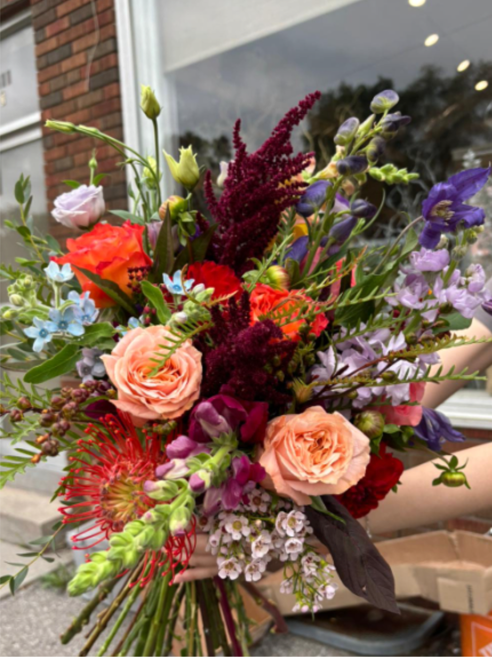Winter 33 - A vibrant mix of fall blooms — rich burgundy, golden peach, and  orange tones, paired with soft purples and fresh greenery. Bursting with texture and color, this bouquet captures the warmth and beauty of the autumn season. Perfect for celebrating fall moments, gifting, or adding a cozy touch to your home.  *Depends on availability, flowers may change 