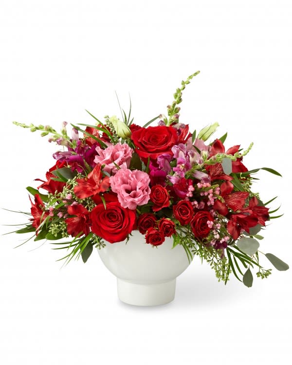 Passion Bouquet II - Share your love with an arrangement filled with love and passion within each bloom. A collection of red roses, pink double lisianthus, and burgundy snapdragons makes up our Passion Bouquet II. Complemented by eucalyptus, and placed in a white bowl, this gift is a sure to be a favorite for every occasion.