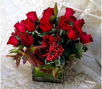 Peace and Freedom - Cube centerpiece with 20 Red Freedom Roses with Berries and Autumn leaves to give a festive feel to the roses. 