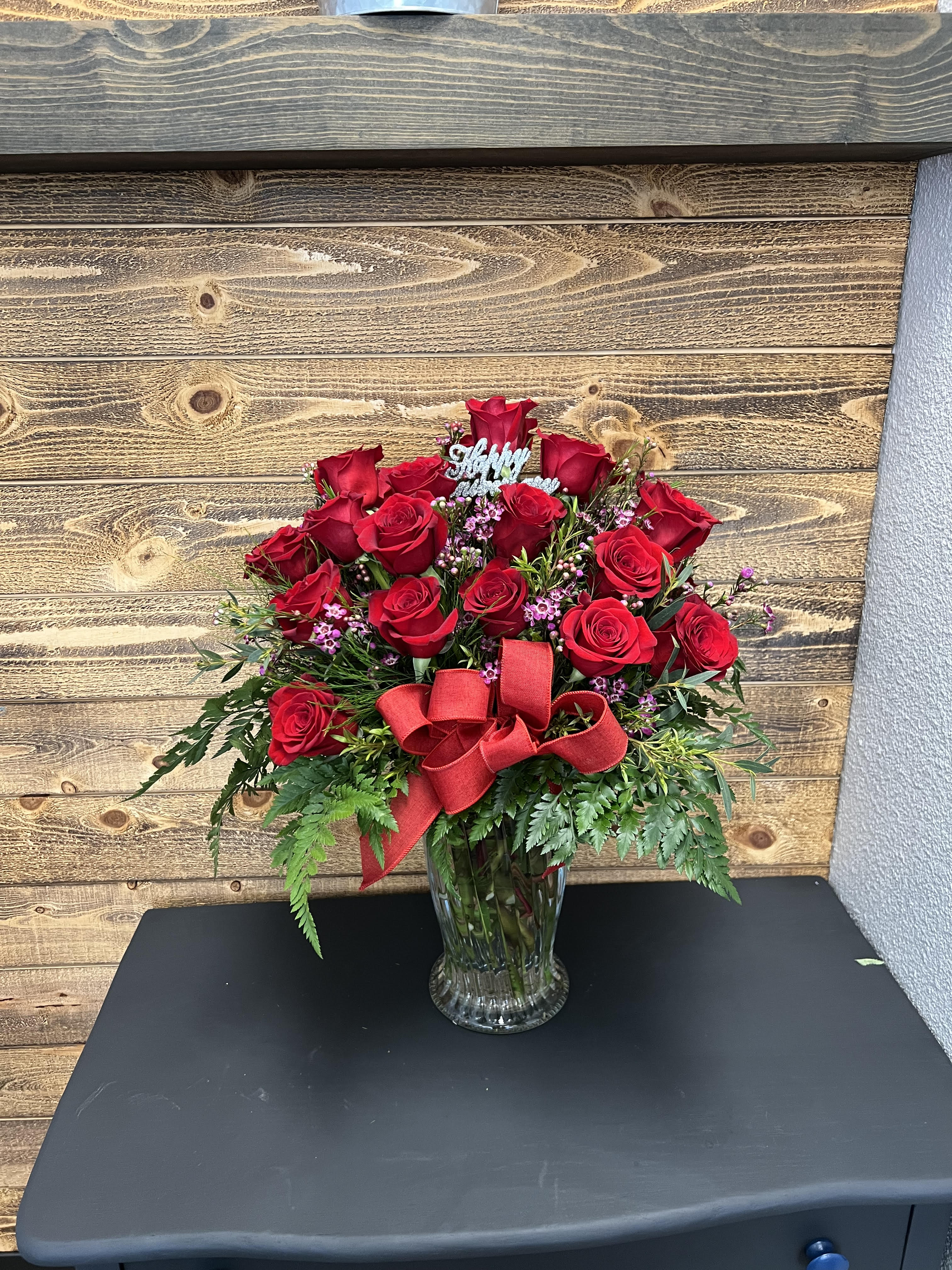 Long Stemmed Red Roses -  Twenty-four stunning red roses are arranged with greenery and filler in a vase. Approximately 24" W x 26" H