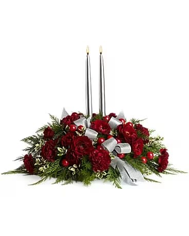 Berries and Blooms - Bring elegance to the holiday table with red roses and maroon carnations accented with a lush array of greenery and berries. All beautifully illuminated by two silver taper candles. It's finishing touch to a fabulous feast.