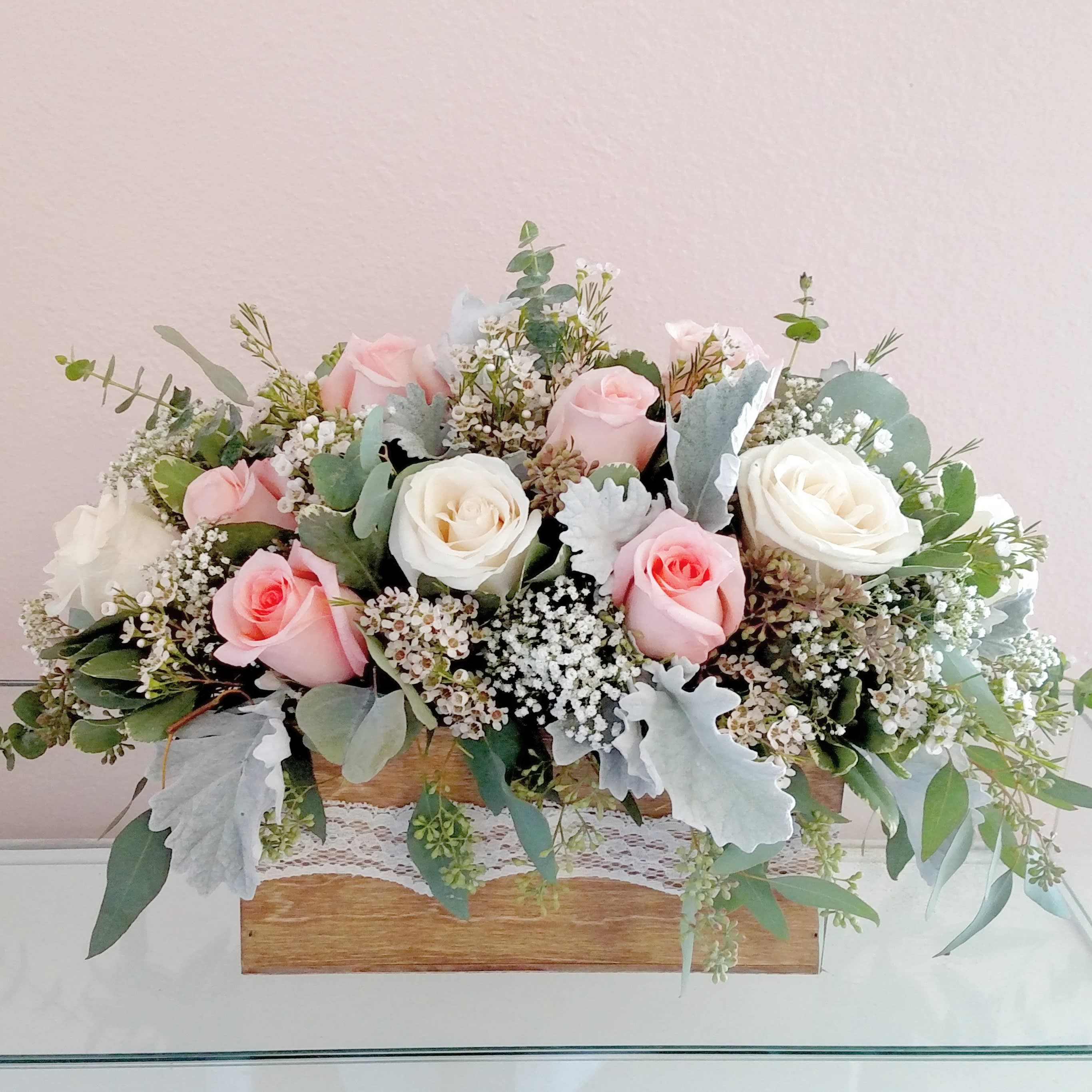 Vintage Dozen - A dozen roses on two soft colors with dusty Miller, eucalyptus, gypsy and wax in a wooden box with lace trim. 