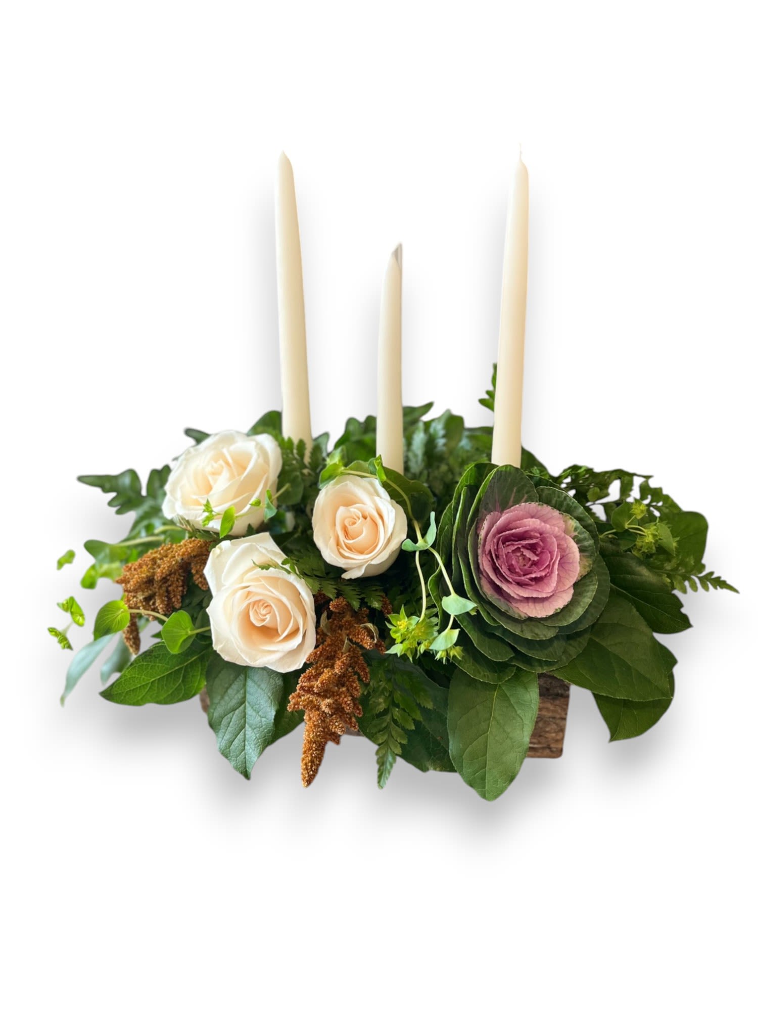 Thanksgiving Harvest Centerpiece - Cream pillar candles, cream roses, kale and assorted greenery inside of a rustic wooden log container