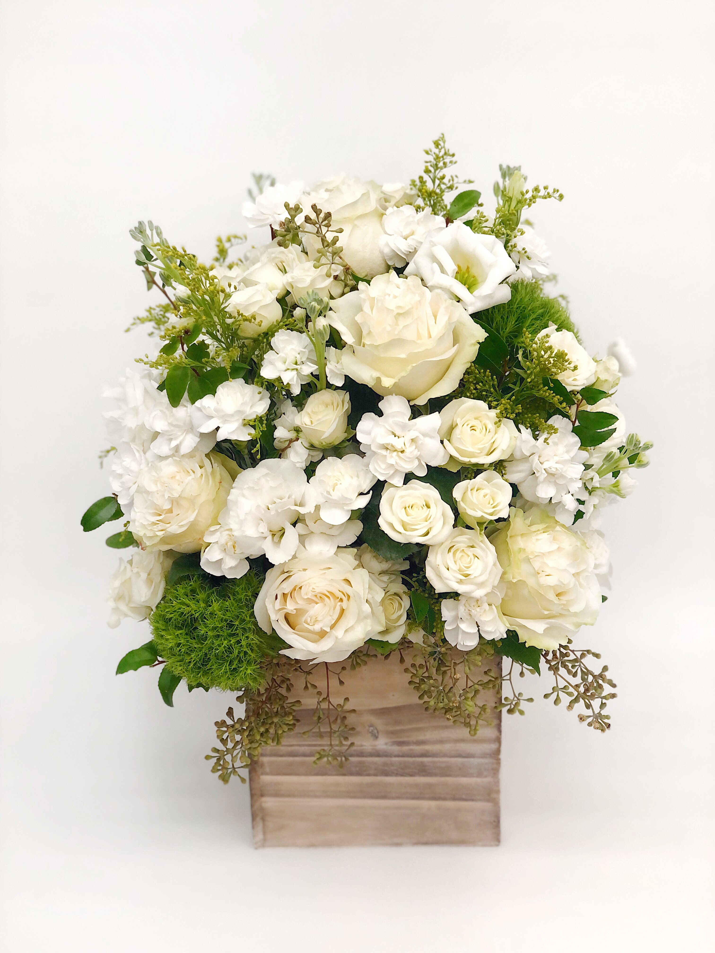 Tall wood box arrangement white - Mixed flowers, from romantic and gentle to an edgy and interesting look. If You want a bouquet with a twist, choose our flower boxes. We have wood boxes for rustic-looking arrangements or hat boxes for a more elegant look. It’s a beautiful and convenient way. Flowers in boxes don’t need vases. That makes it perfect for transportation and keeping flowers hydrated and secure.