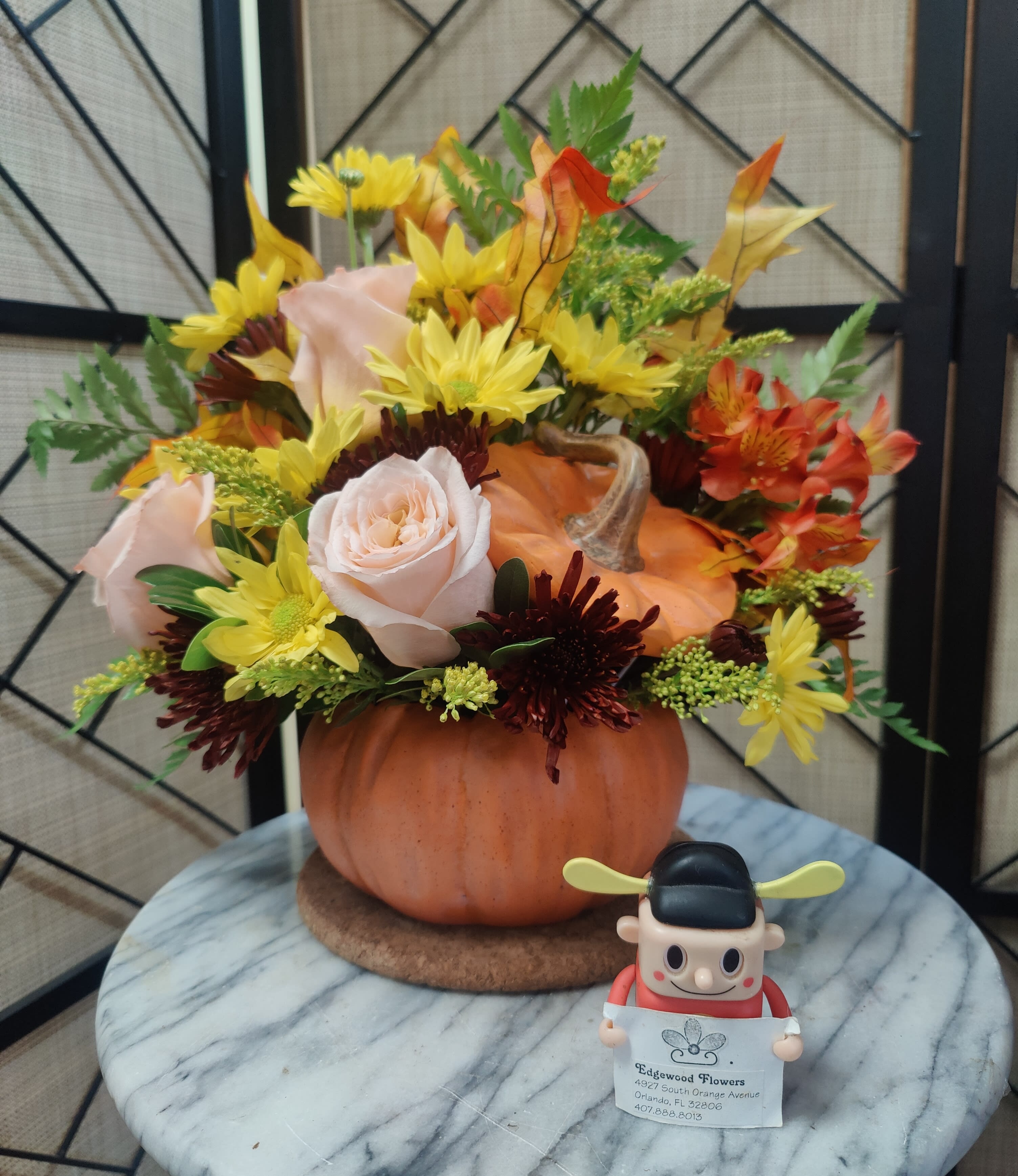 Warm Fall Wishes Bouquet - Everyone falls for this fabulous fall gift! Celebrate the season with this autumn arrangement of roses and alstroemeria, arranged in a classic ceramic pumpkin they'll use year after year!  Includes a lush mix of orange roses, orange alstroemeria, burgundy cushion chrysanthemums, yellow daisy chrysanthemums, solidago, huckleberry and oak leaves. Delivered in an exclusive ceramic pumpkin with lid.  Approximately 15&quot;w x 14&quot;h