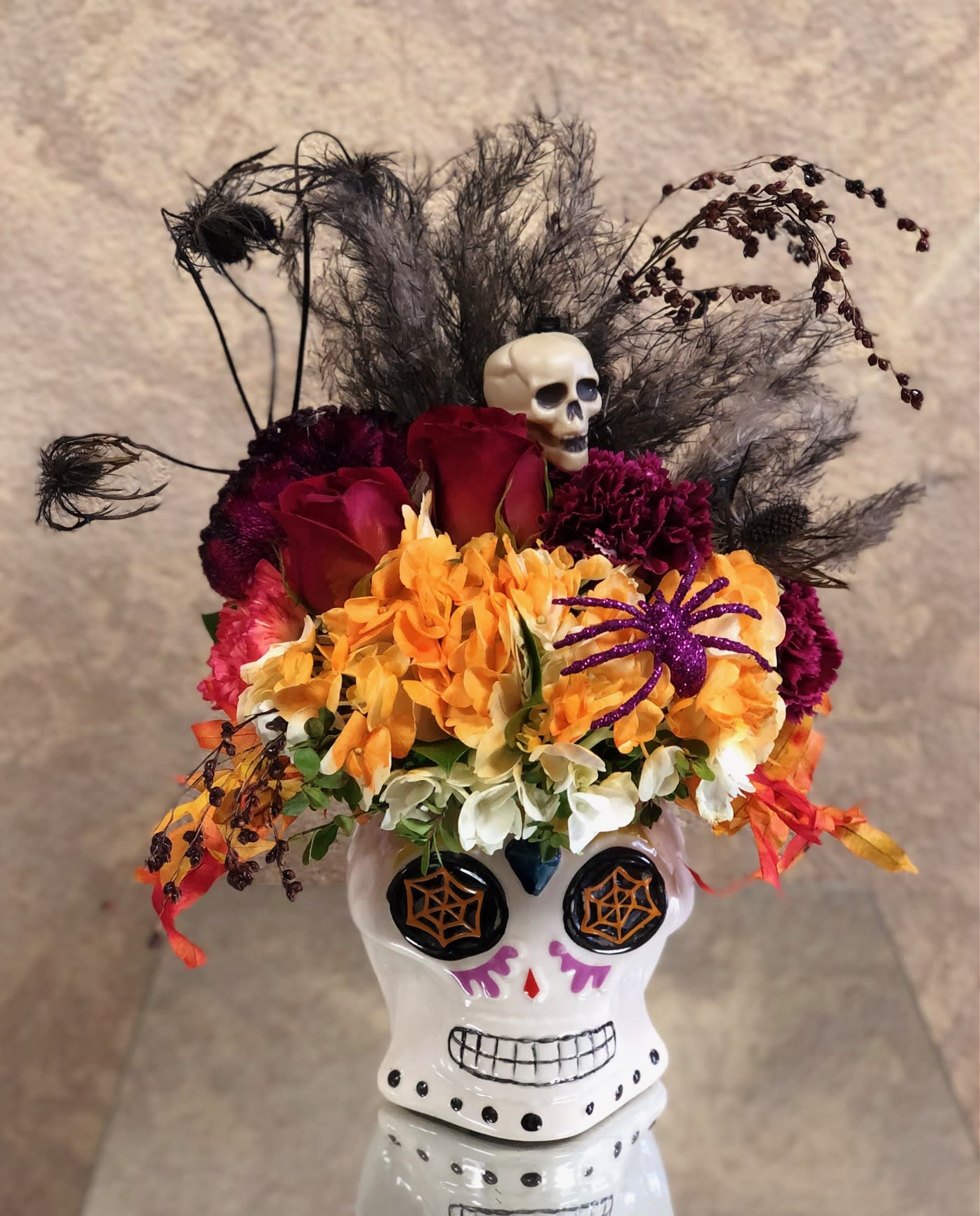 Morticia 2 - Send this cute Morticia mug with Halloween accents to someone special this Halloween.  This arrangement includes hydrangea, red roses, carnations, and fillers. Availability: October Only Design View: Symmetric Front Facing View Photo shown: Standard 