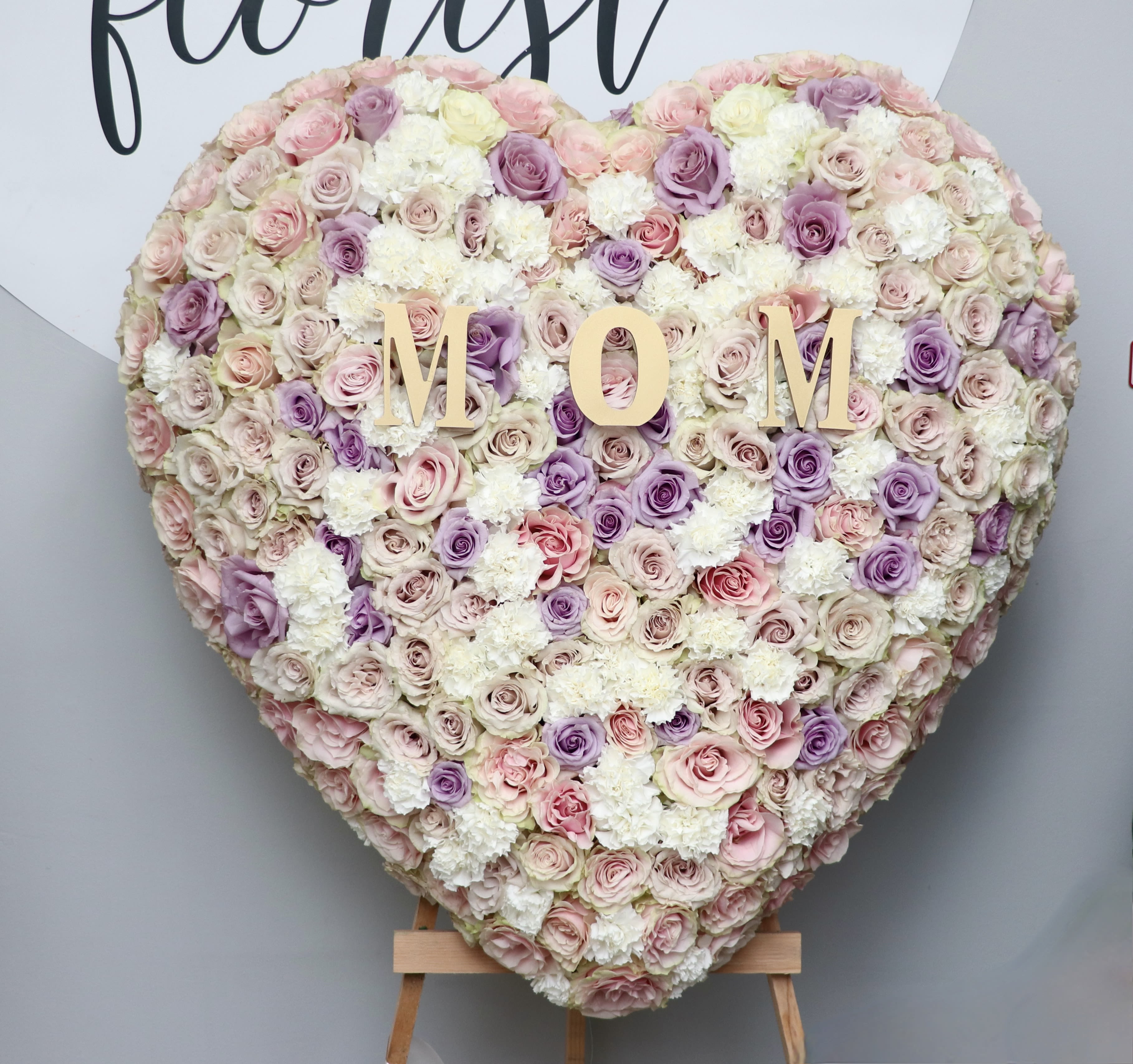 MOM Full Heart  - Covered in roses, this full heart can also includes letters of your choice.  We include easel, printed banner and delivery (some fees may apply). An additional banner can be added for $15  Standard size is 30'', deluxe is 36'', and premium is 42''.