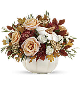 Harvest Charm Bouquet - This charming arrangement features crème roses, white miniature carnations, burgundy cushion spray chrysanthemums, yellow cottage yarrow, olive, and brown copper beech. Delivered in an Enchanted Harvest Pumpkin. Approximately 18&quot; W x 13 1/2&quot; H 
