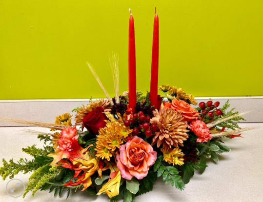 Free Spirit Table Arrangement - Enjoy your Thanksgiving dinner with a beautiful view! This beautiful arrangement features bright peachy orange roses with autumn mums and colorful accent flowers.