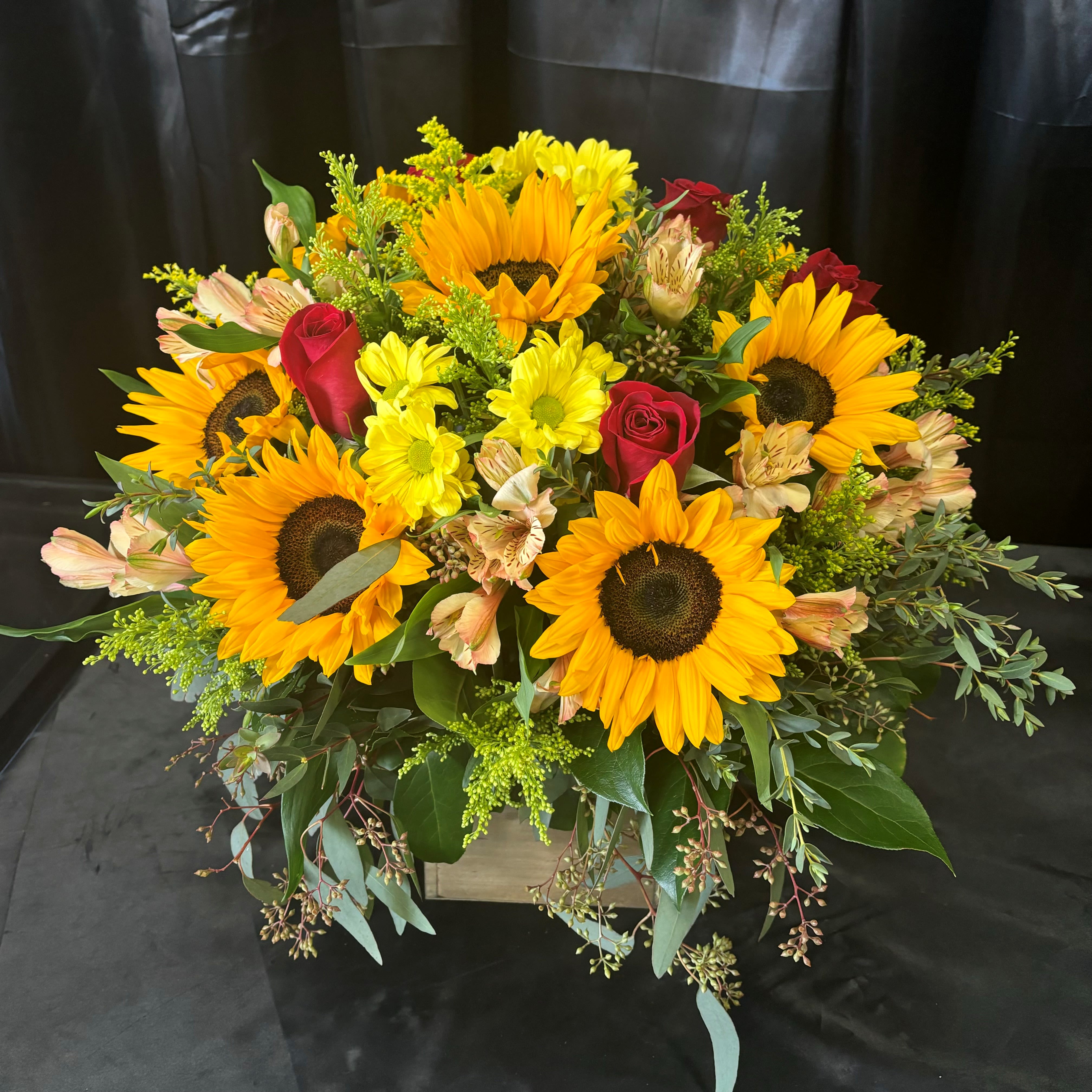 Country Field with Roses - Beautiful combination of Sunflowers and Red Roses with mixed filler flowers and greens in a wooden box container. Please put in the special instructions if you would like a different color of rose color