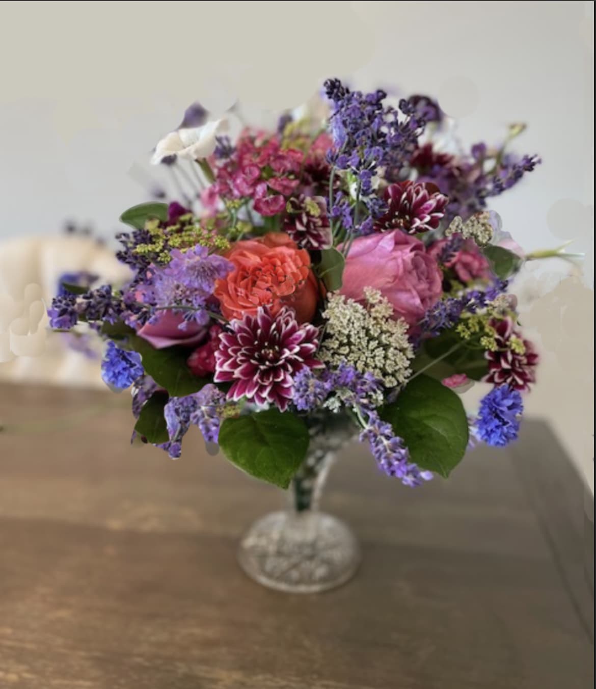 Wine glass overflowing - filled to the brim with lavender, fresh flowers like roses, ranunculus, stock, snapdragon, batchelor button, and orlaya  (flowers will vary due to what is available at the time of order but overall look will be the same )