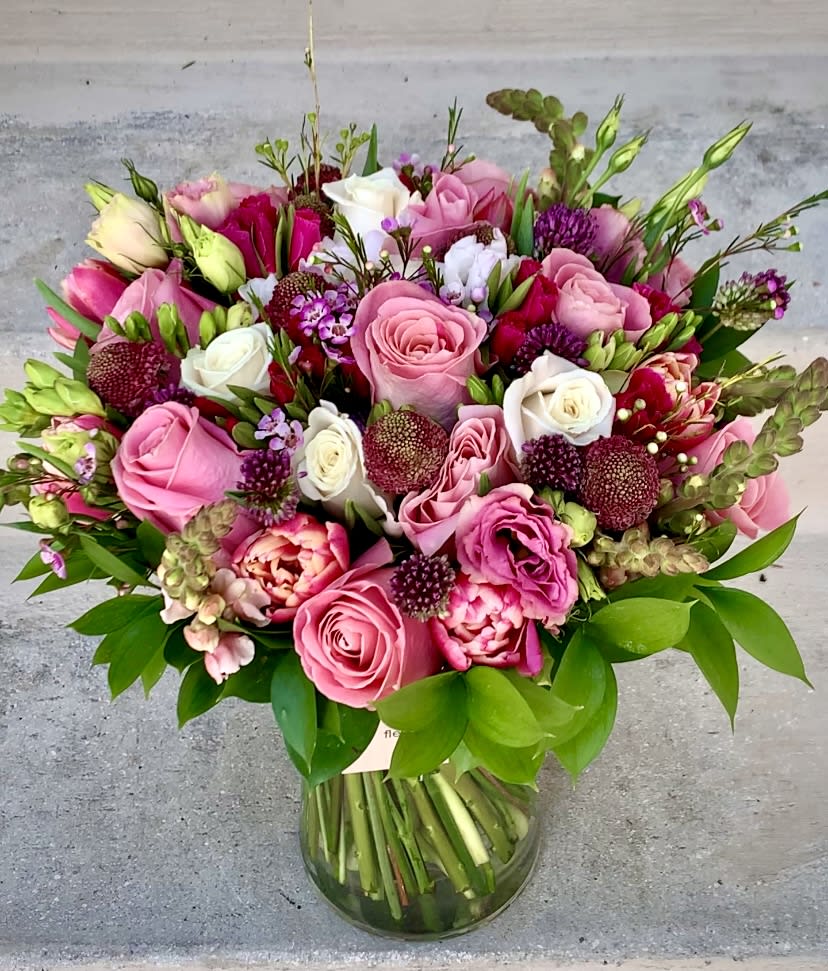 unique garden - This luxury arrangement contains mixed florals such as roses, peonies, spray roses, lisianthus and others, beautifully laid out in a glass vase. Handwritten card is included. Send the most beautiful flowers for that special someone. Next day delivery available to Tequesta, Jupiter, Palm Beach Gardens and Palm Beach.