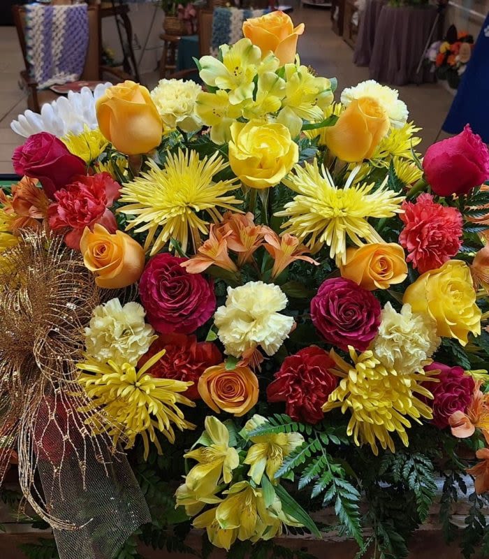 Bountiful Blossoms  - Bright yellow roses, spider mums, alstroemeria with red roses and red carnations.