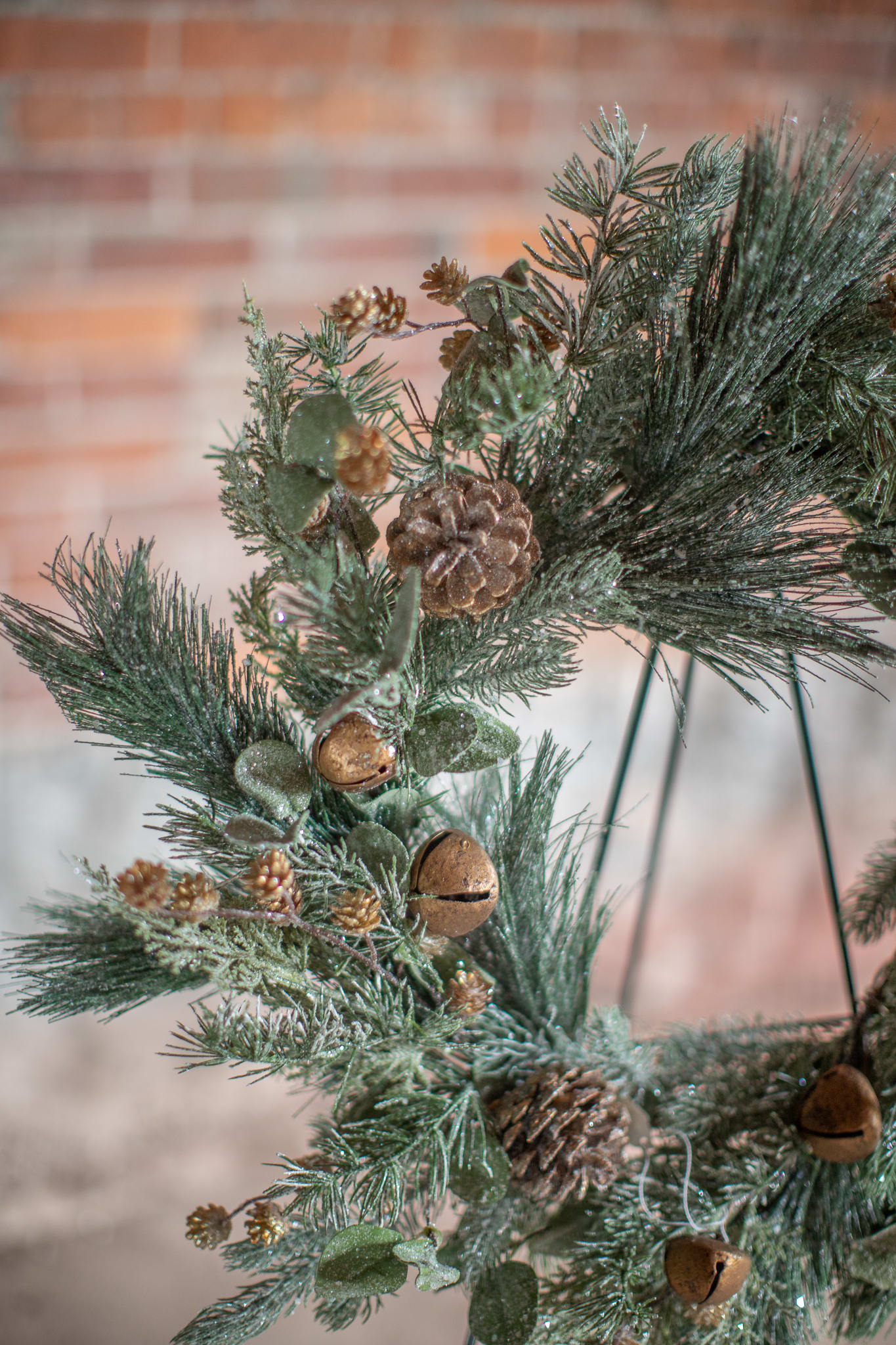 SALE! Gold Jingle Bells Wreath (Artificial) - Twinkling glittery winter foliage of pines, silver dollar eucalyptus, and cedar varieties decorated with gold pine cones, melodic rustic gold bells. Perfect to deck the halls. 22 inch overall diameter. Permanent floral decor is the gift that keeps on giving year after year.