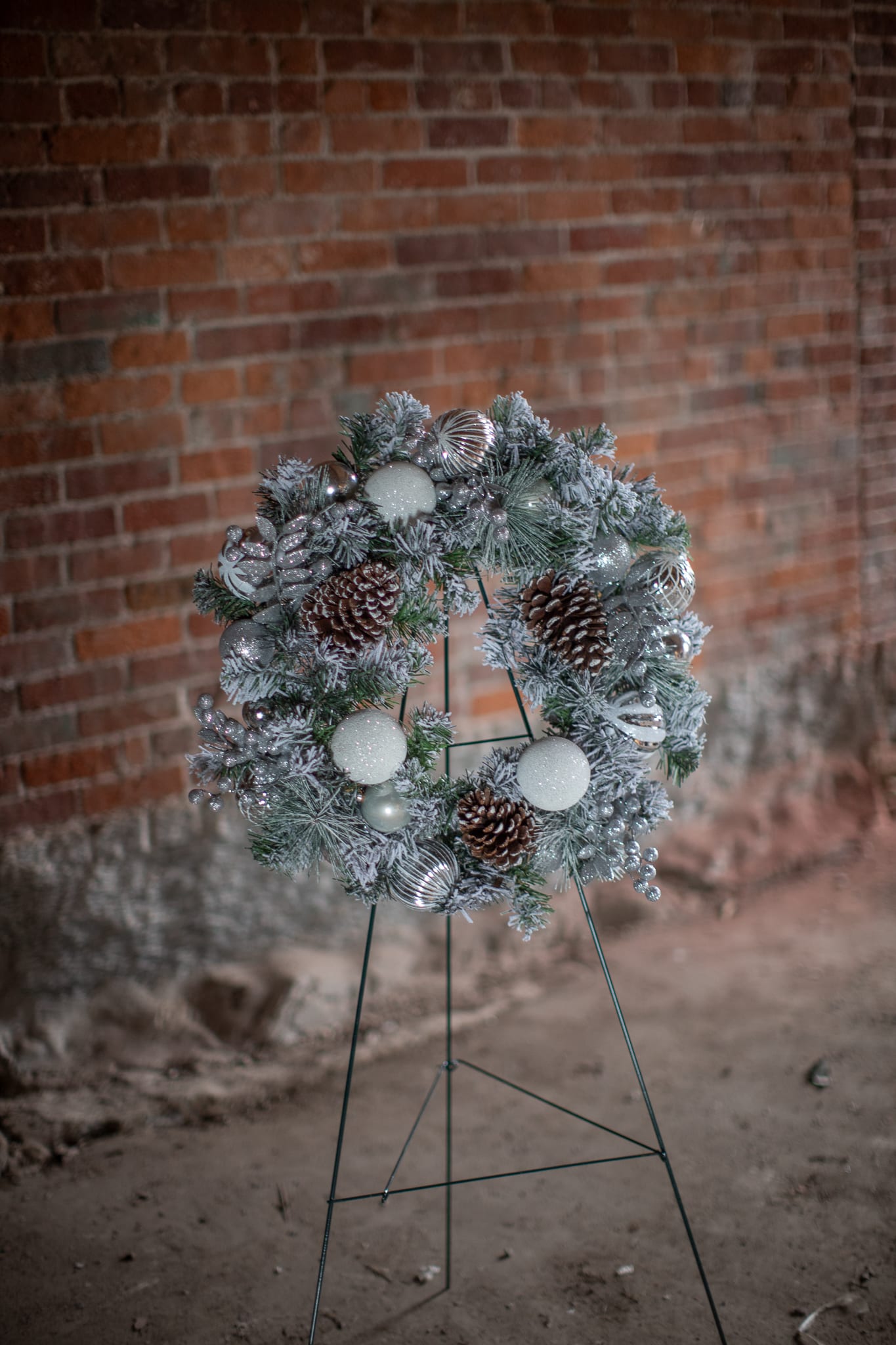 SALE! Sterling Flocked Wreath (Artificial) - Winter whites paired with shining silver elements are sure to catch the eye of passers by. This permanent wreath is flocked for a snow-kissed look. Shimmering silver artificial ruscus foliage and berries create a timeless winter look. Overall diameter is 24 inches.