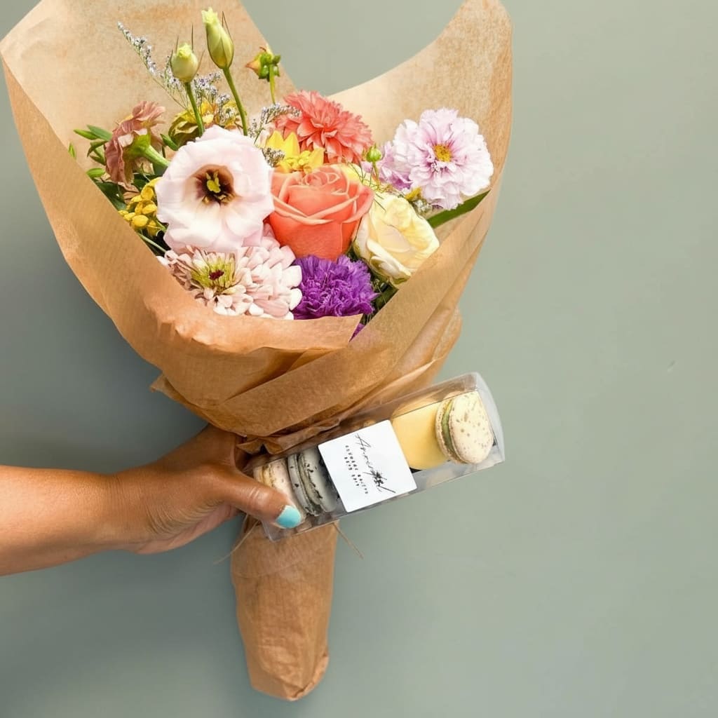 Sweet Blooms &amp; Bites Bundle (No Vase) - Give the gift of color and indulgence with our Sweet Blooms &amp; Bites Bundle. This joyful set includes a handcrafted bundle of fresh, locally grown flowers — bursting with color and charm — paired with a gourmet box of French macarons. USDA-certified organic, natural ingredients, gluten-free, and made with real ingredients (no dyes or preservatives).  Perfect for birthdays, client gifts, or a thoughtful surprise! 	•	Flower bundle made with local and farm-fresh seasonal blooms 	•	Macaron box includes assorted flavors (6-count) 	•	Available for pickup or local delivery 