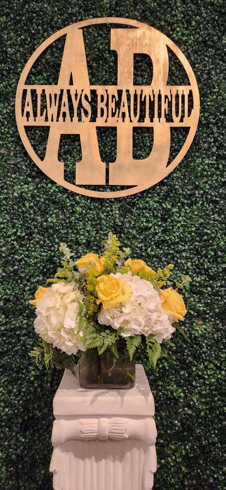 Hydrangea &amp; Roses - This elegant floral arrangement combines the timeless beauty of soft white hydrangeas and vibrant yellow roses. The flowers are complemented by fresh greenery, including eucalyptus and ferns, adding a touch of lush texture. Arranged in a modern square glass vase, this piece brings a sophisticated yet cheerful vibe to any setting.  Perfect for brightening up a room, celebrating a special occasion, or adding a touch of elegance to a wedding or event, this arrangement exudes a sense of warmth and refinement. *Standard Pricing is As Shown*