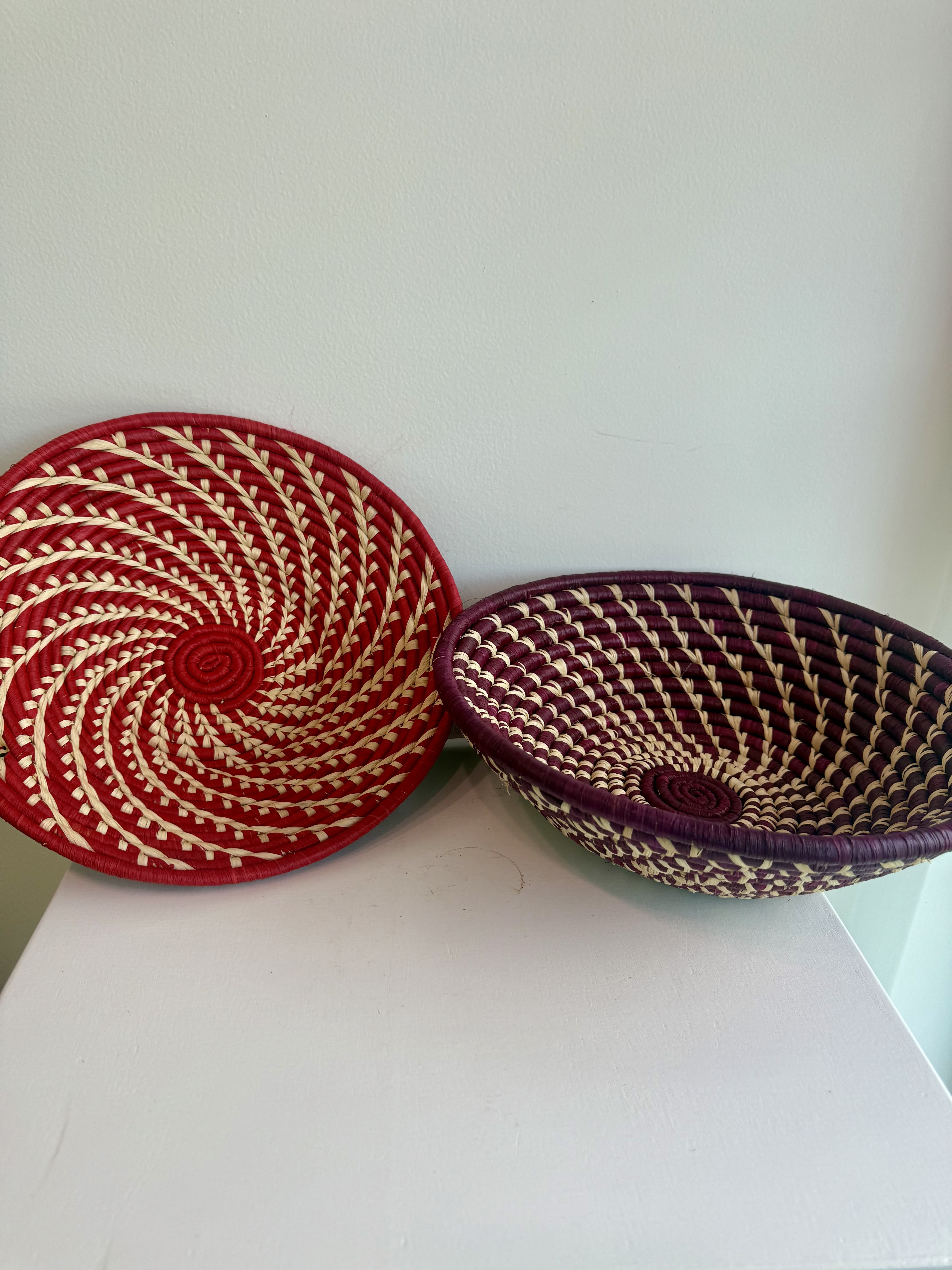 BEYOND UGANDA GRASS BASKET - The perfect basket for decoration or to hold everyday used items! This item is a part of the Beyond Uganda program RUTH. RUTH stands for Redeem Uplift Thrive and Hope. The program exists to train women in the business of crafting and creating for self-sustainability. Through purchasing items your partnership creates economic, educational, and eternal change for women in Uganda. All items are made by the women in Uganda!  We currently have baskets that are purple, beige, black, teal, red, and orange! If you have a preference of color please leave a note at checkout or call the store and we will accommodate your preference to the best of our abilities!