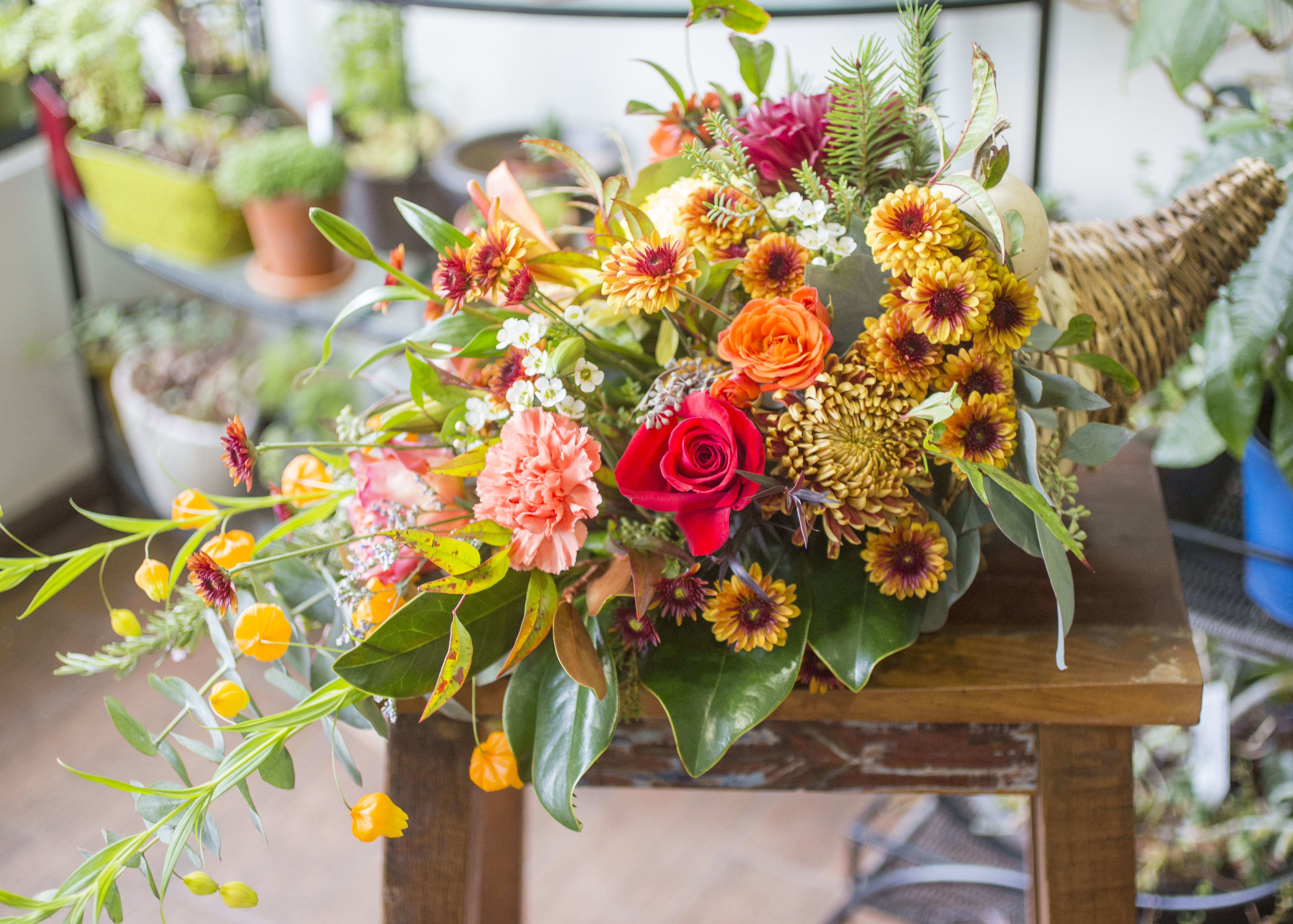 Maura - Thanksgiving cornucopia with seasonal flowers and accents.