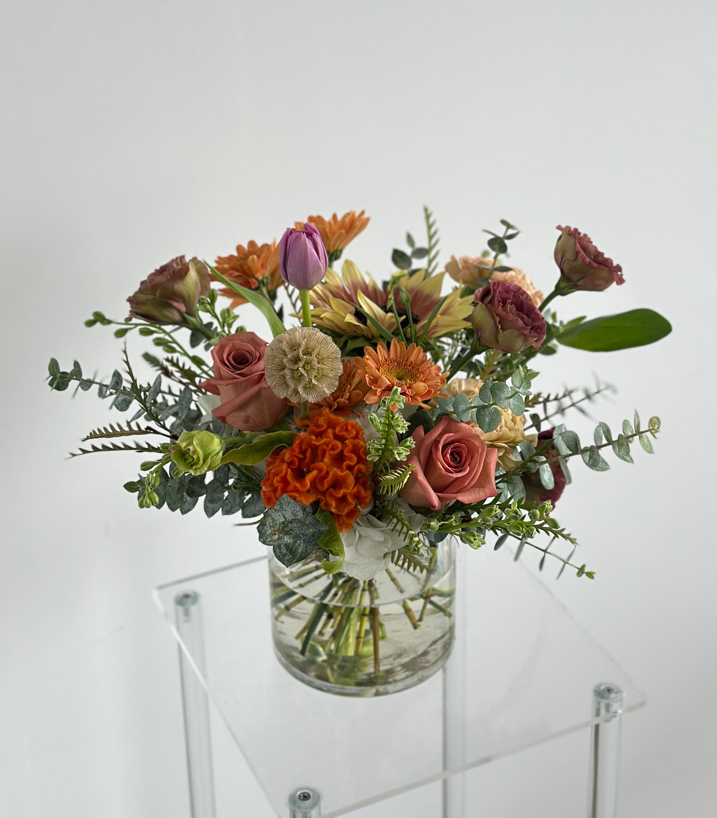 Spiced Jam - A cozy low vase centerpiece with autumn blooms in golden and rustic tones.  Flower types may vary depending on the season.