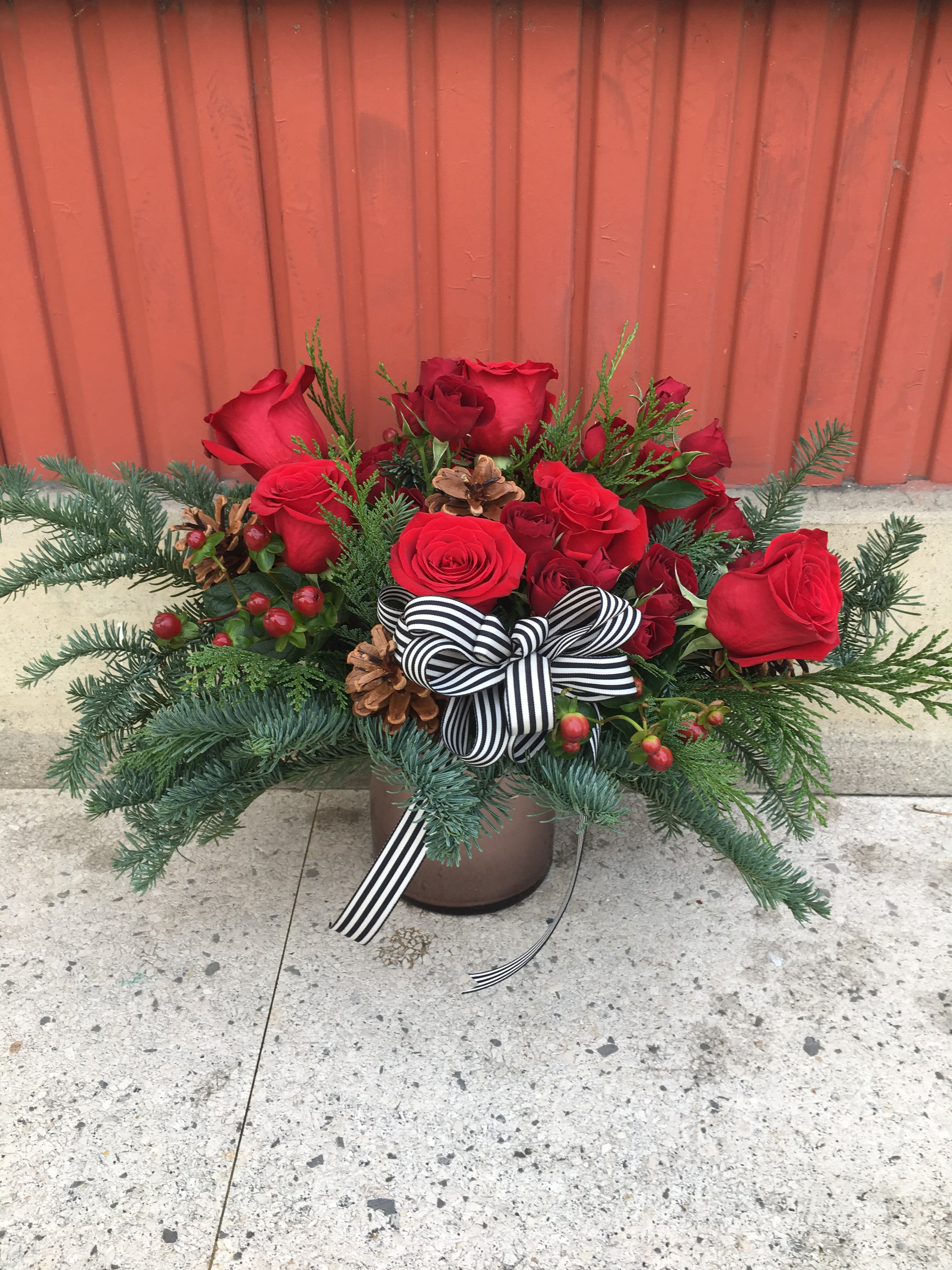 Joyeux Noël - Spread some French Christmas cheer with this beautiful arrangement full of roses, spray roses, berries, cedar, fir and topped with a chic striped ribbon.