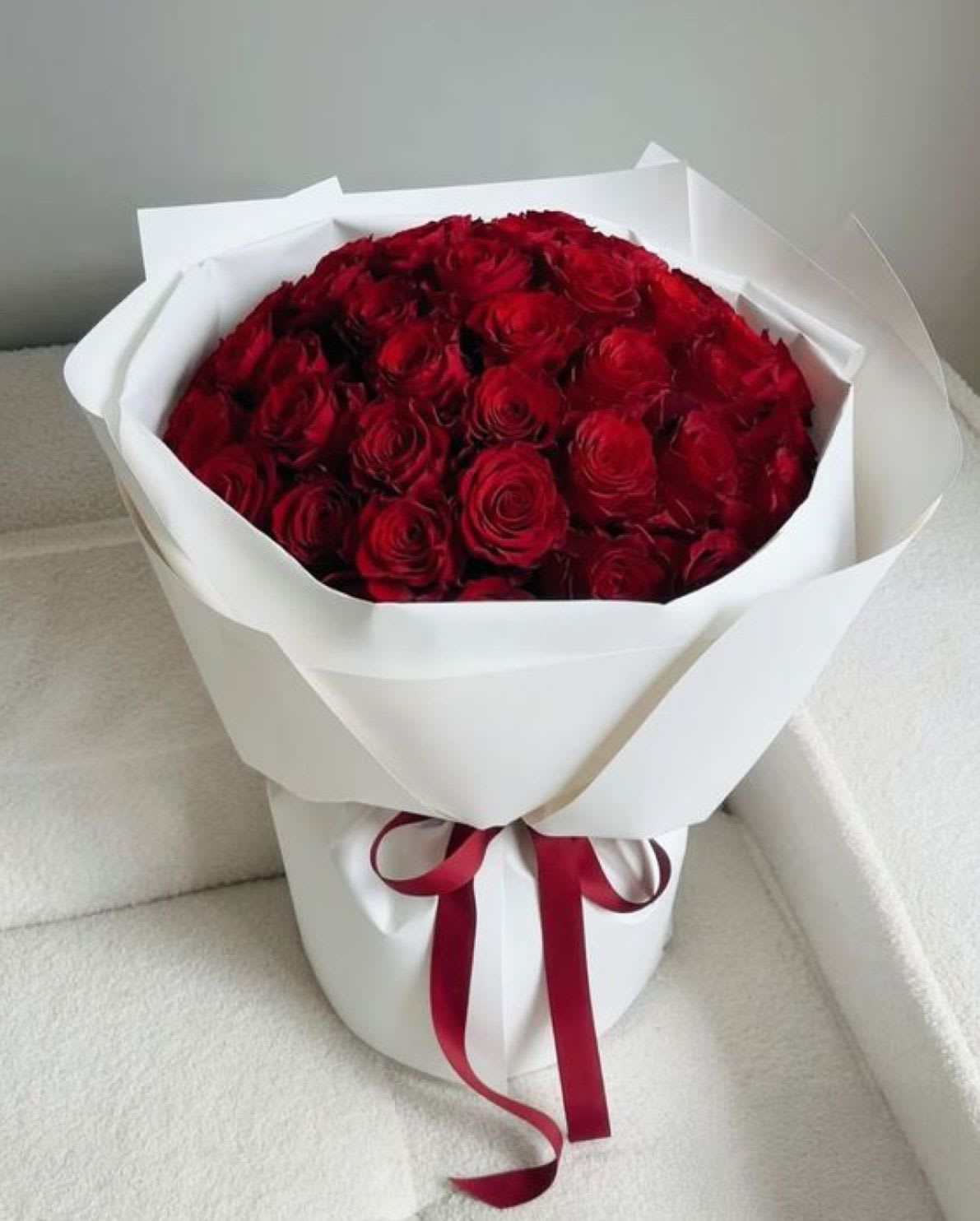 Classic Red - Lush, velvety red roses — the ultimate symbol of love and sophistication. Handcrafted and wrapped in luxurious paper. Vase not included.