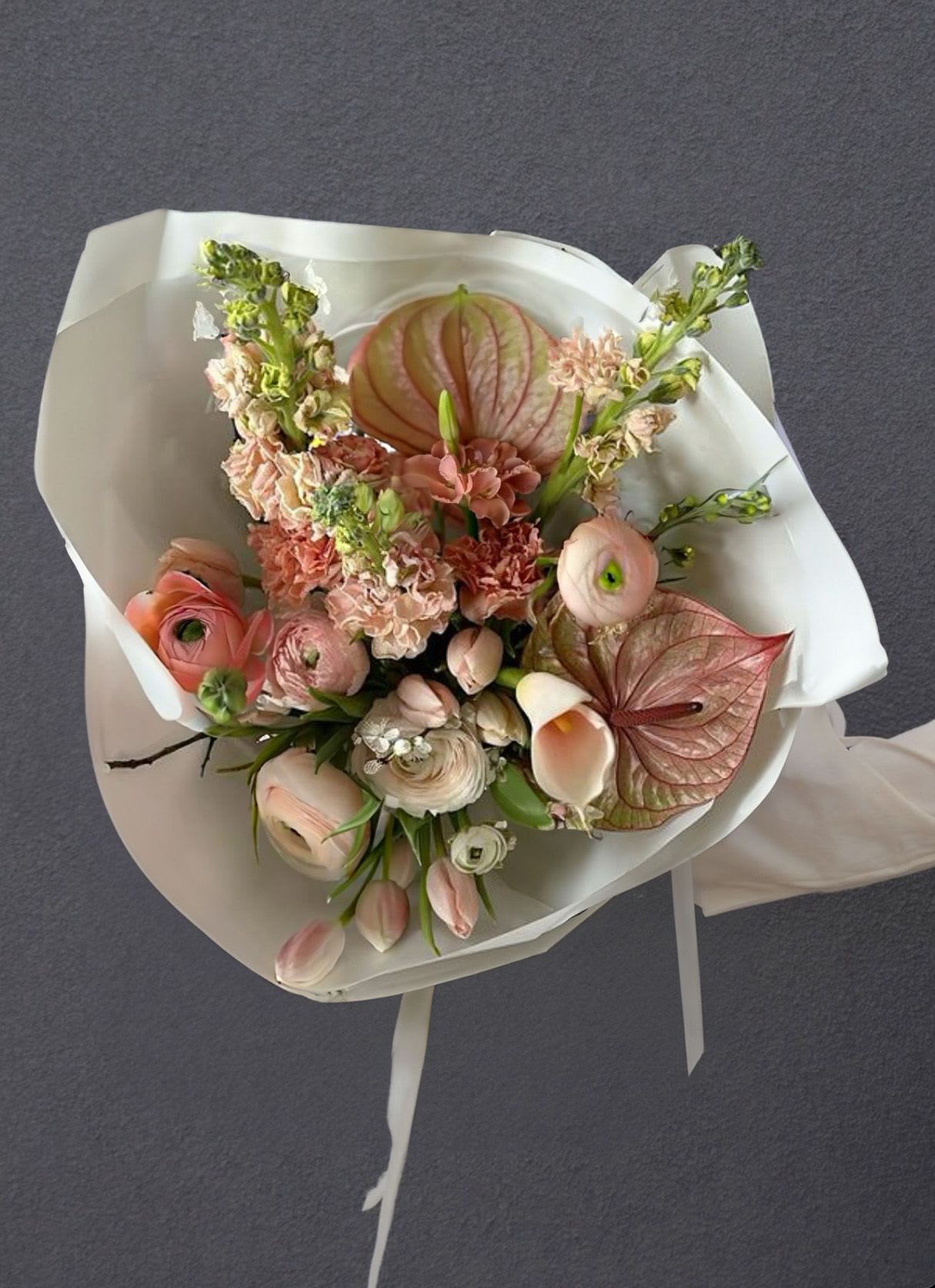 Glossy Petals - A sculptural bouquet in warm nude tones, combining airy elegance with a bold vertical silhouette. Its refined shape and soft textures create a sense of effortless sophistication and quiet confidence.