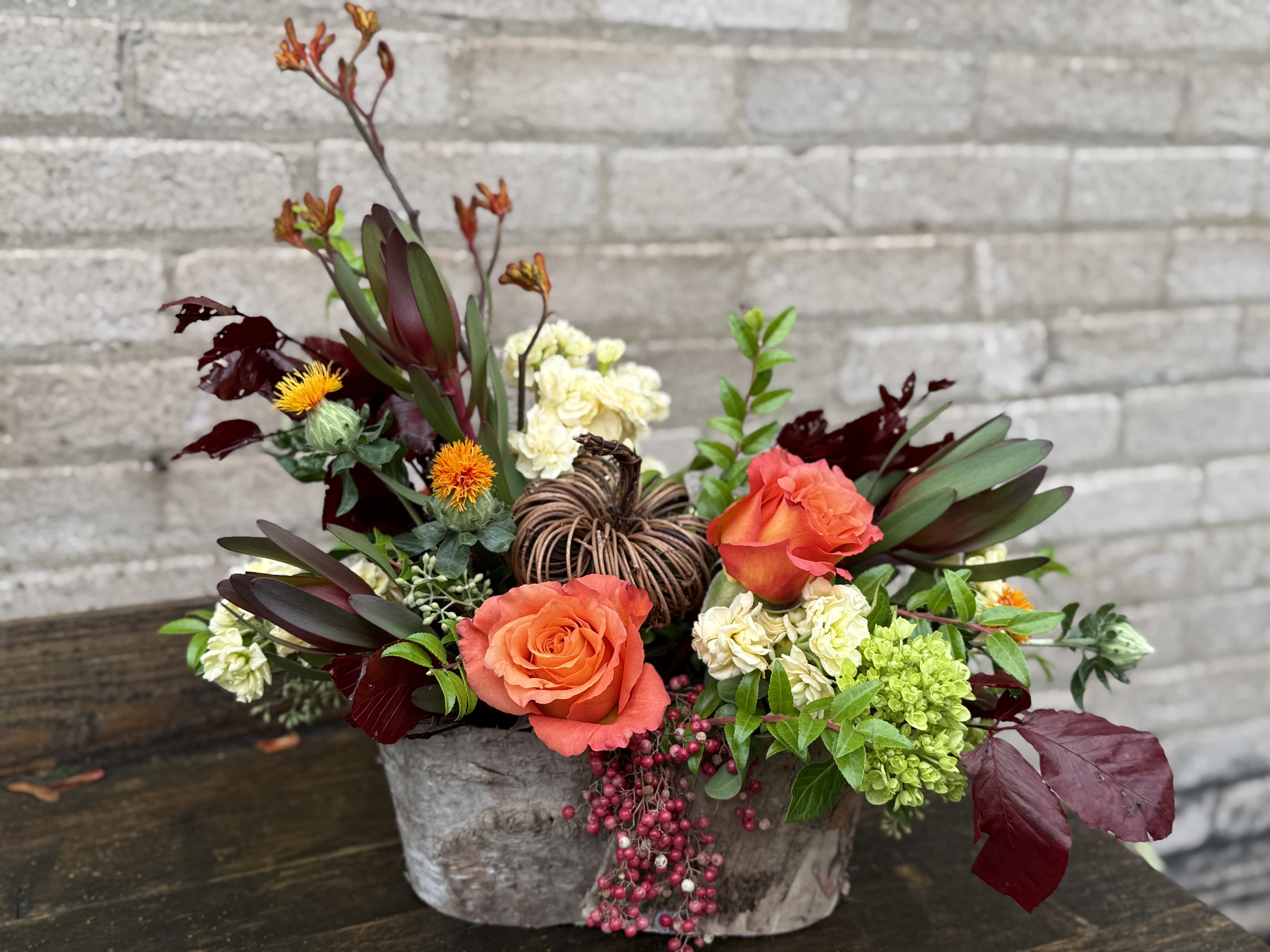 Thanksgiving Radiance - A beautiful arrangement for the Thanksgiving holiday, hostess gift, centerpiece or just to beautify and create warmth in your home at this special time. We have interesting, textural elements and gorgeous blooms which may change from the picture as the season changes.