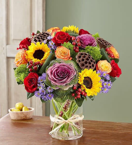  Fall Garden   -  Fall garden is mix of blooms, hand-gathered with unique natural accents inside a cylinder vase. It’s a gift guaranteed to make a grand impression at every gathering.