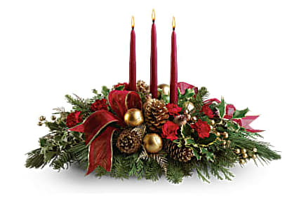 All Is Bright - All is calm, all is bright…well, at least we can promise the latter with this luminous arrangement! Gather family and friends together for a holiday meal around this traditional Christmas centerpiece featuring pinecones, holly, noble fir and Christmas candles. 'Tis the season to shine! A fresh centerpiece of holly, noble fir, white pine, flat cedar, and miniature red carnations is decorated with golden berries, Christmas ornaments, pinecones and three red taper candles. A sheer, gold-edged organza ribbon adds to the opulence. Orientation: All-Around