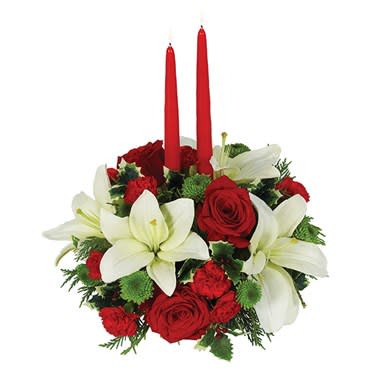 Traditional Holiday Centerpiece - As friends and family gather around the holiday table, they?re sure to be delighted by this wonderful centerpiece featuring white Asiatic lilies, red roses, red mini carnations and green button poms. A pair of 12-inch red taper candles adds to the celebratory mood. Small Measures 10&quot;H by 8&quot;L. Medium Measures 11&quot;H by 8&quot;L. Large Measures 11&quot;H by 8&quot;L.