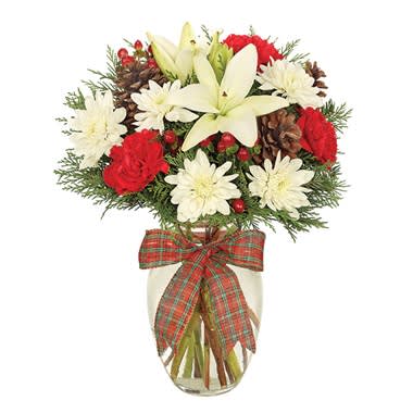 Holiday Joy Bouquet - Oh the weather outside is frightful, but who  cares as this extraordinary holiday arrangement will brighten anyone's day!  A lovely rose vase is the setting for Asiatic lily, carnations, roses, cushion poms and hypericum…accented with pine cones and a jovial plaid ribbon.